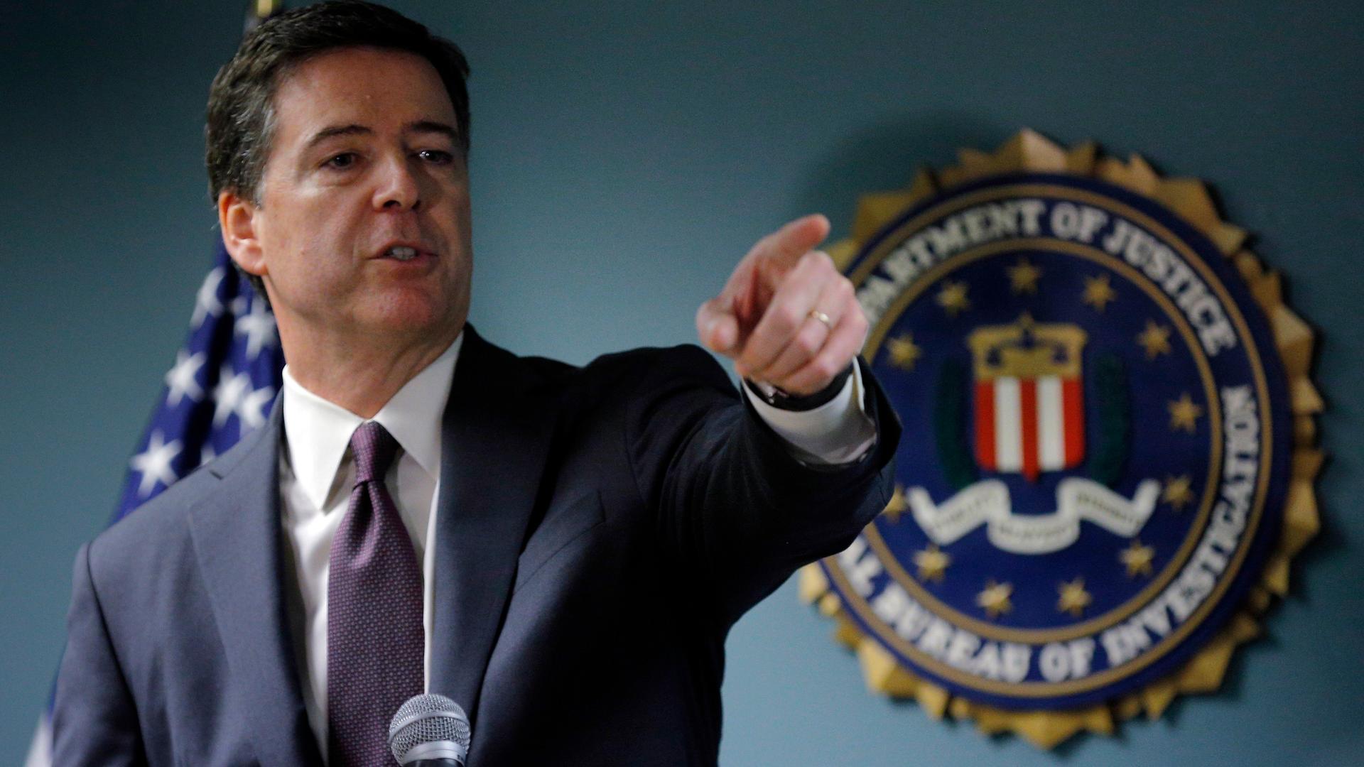 FBI Director James Comey takes a question from a reporter during a news conference at the FBI field office in Boston, Massachusetts, on November 18, 2014.
