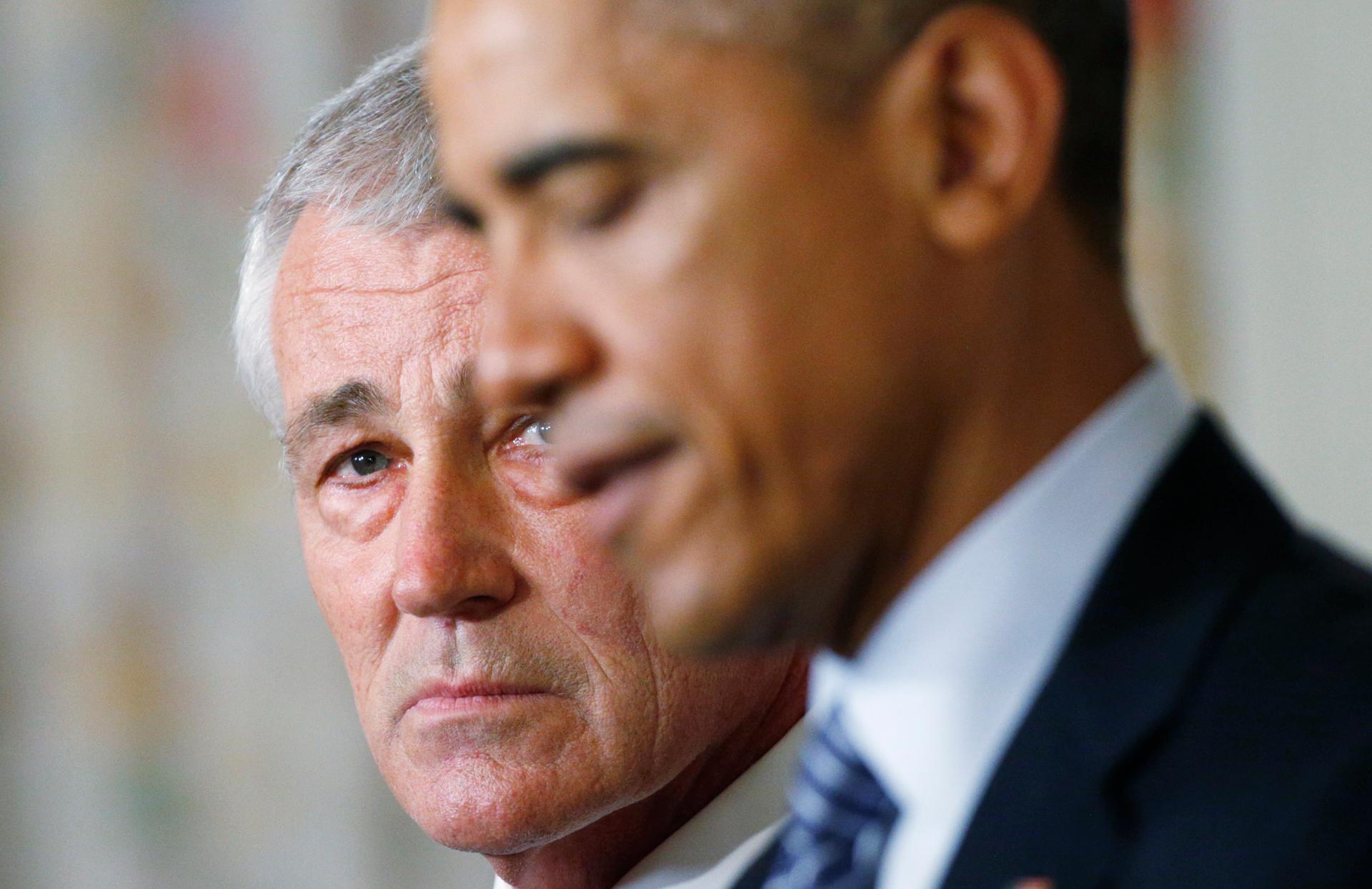 Defense Secretary Chuck Hagel listens as President Barack Obama announces Hagel's resignation.