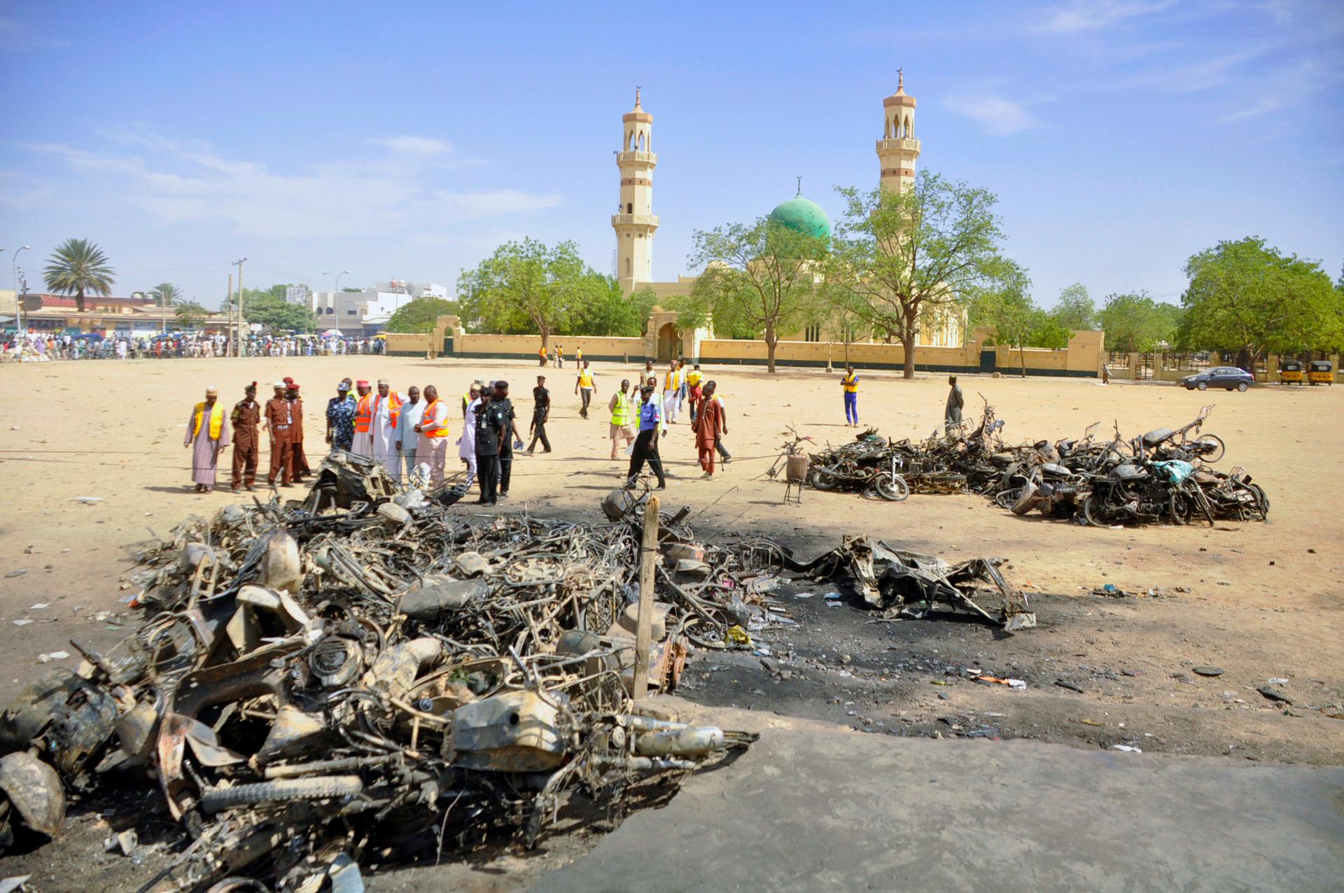 Police and emergency workers investigate a bombing scene in Kano, Nigeris, on November 29, 2014.