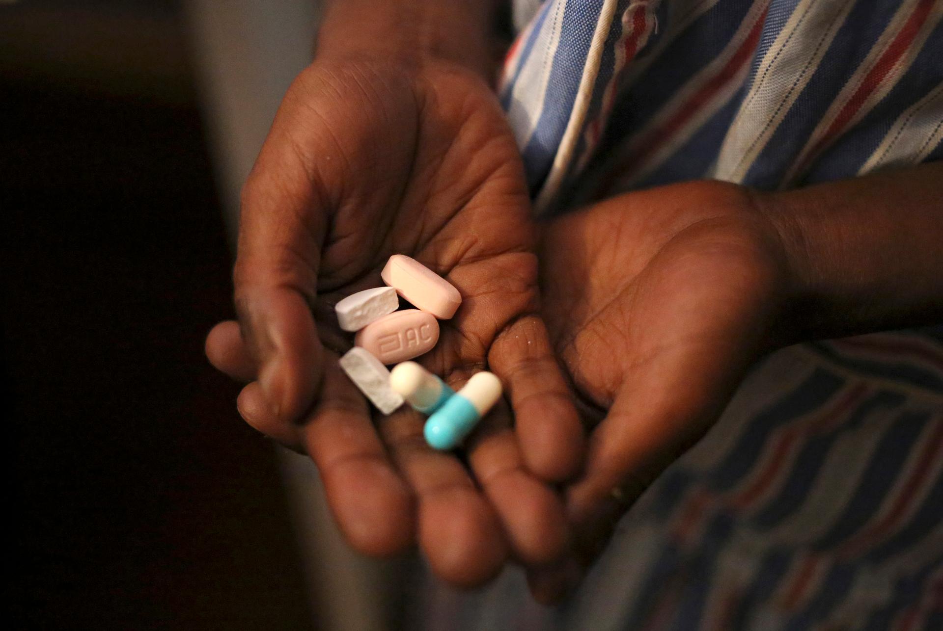 Nine-year-old Tumelo shows off antiretroviral pills before taking his medication at Nkosi's Haven, south of Johannesburg. Such anti-AIDS drugs are used as part of the cheap, illegal cocktail known as "nyaope."
