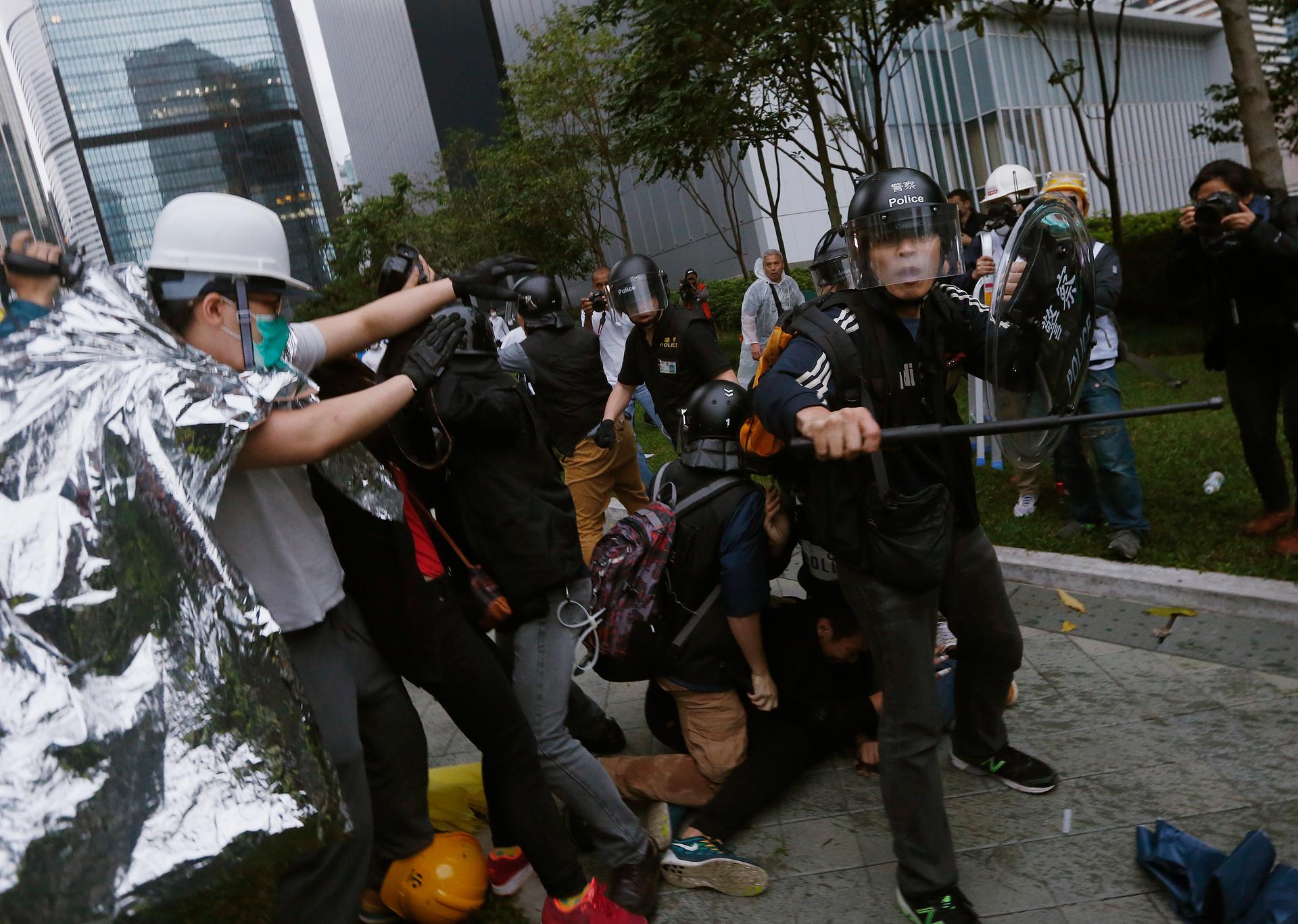 Hong Kong police baton-charged and pepper-sprayed thousands of pro-democracy demonstrators in the early hours of December 1, 2014. The protesters were trying to encircle government headquarters, defying orders to retreat after more than two months of prot