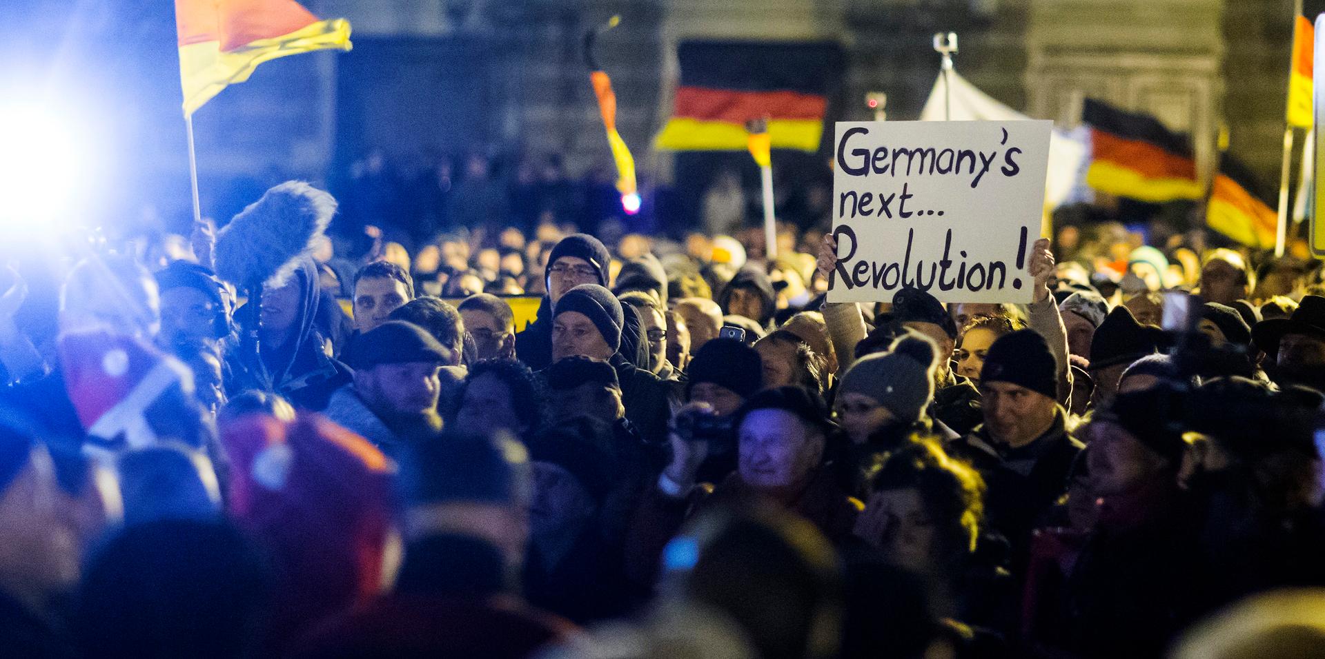 A woman holds a sign during a demonstration organised by anti-immigration group PEGIDA, a German abbreviation for "Patriotic Europeans against the Islamisation of the West", in Dresden December 22, 2014.