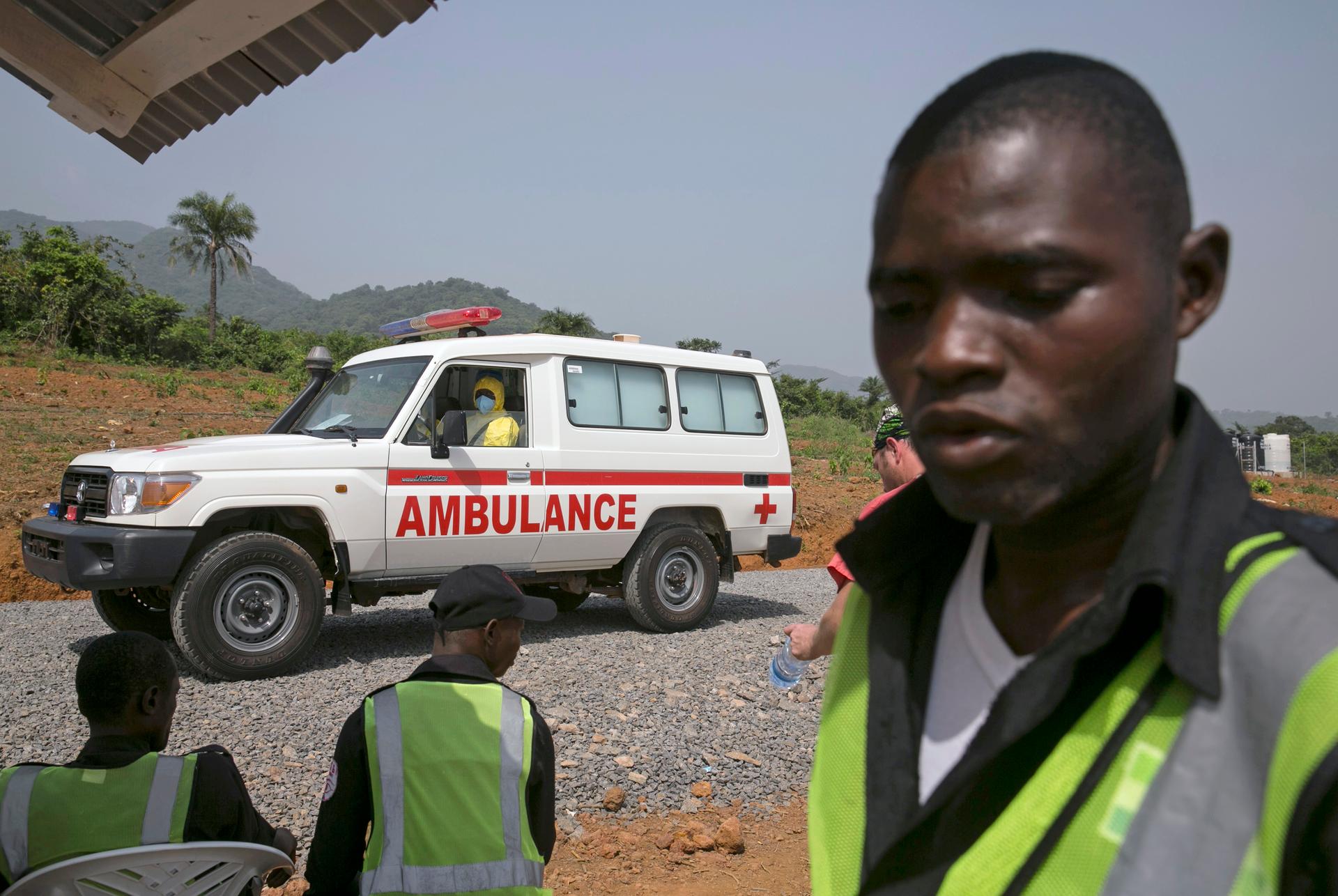 An ambulance transporting an Ebola patient drives to the entrance of a treatment centre outside Freetown, Sierra Leone.