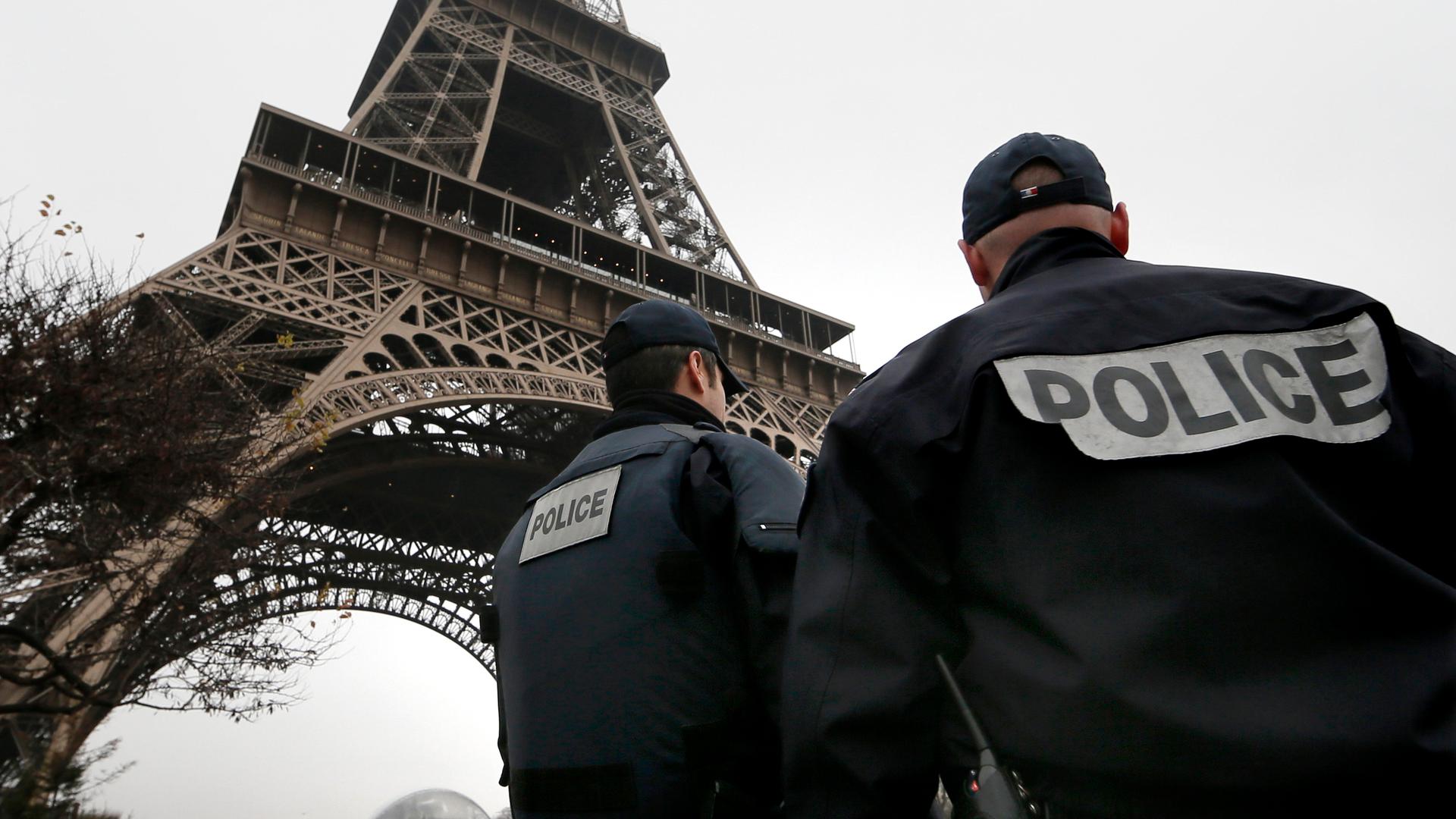 French police patrol near the Eiffel Tower in Paris as part of the highest level of "Vigipirate" security plan after a shooting at the Paris offices of Charlie Hebdo on January 7, 2015.