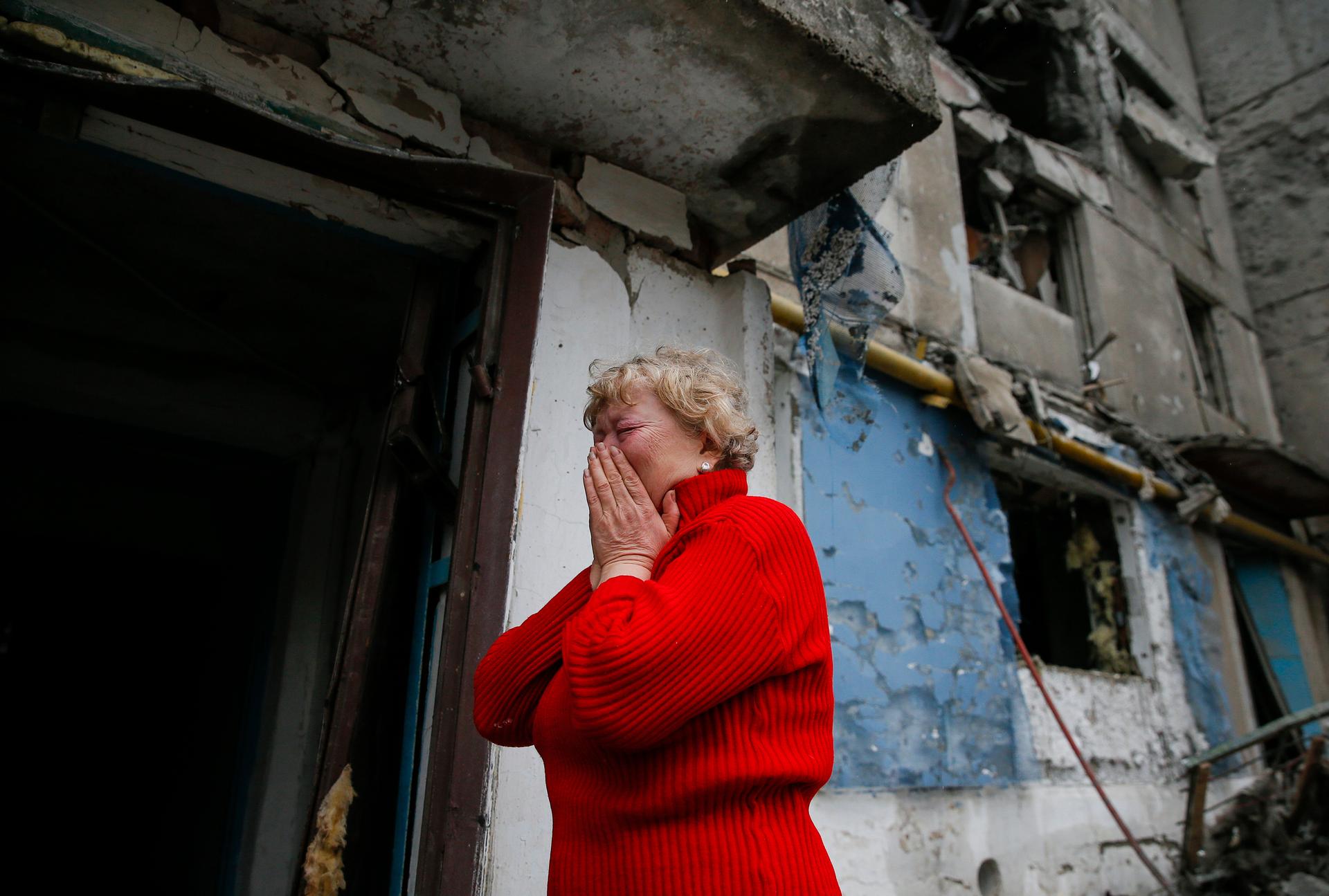 A woman takes stock of the damage to an apartment block, hit by shelling in a small town near Debaltseve, Ukraine on February 2, 2015.
