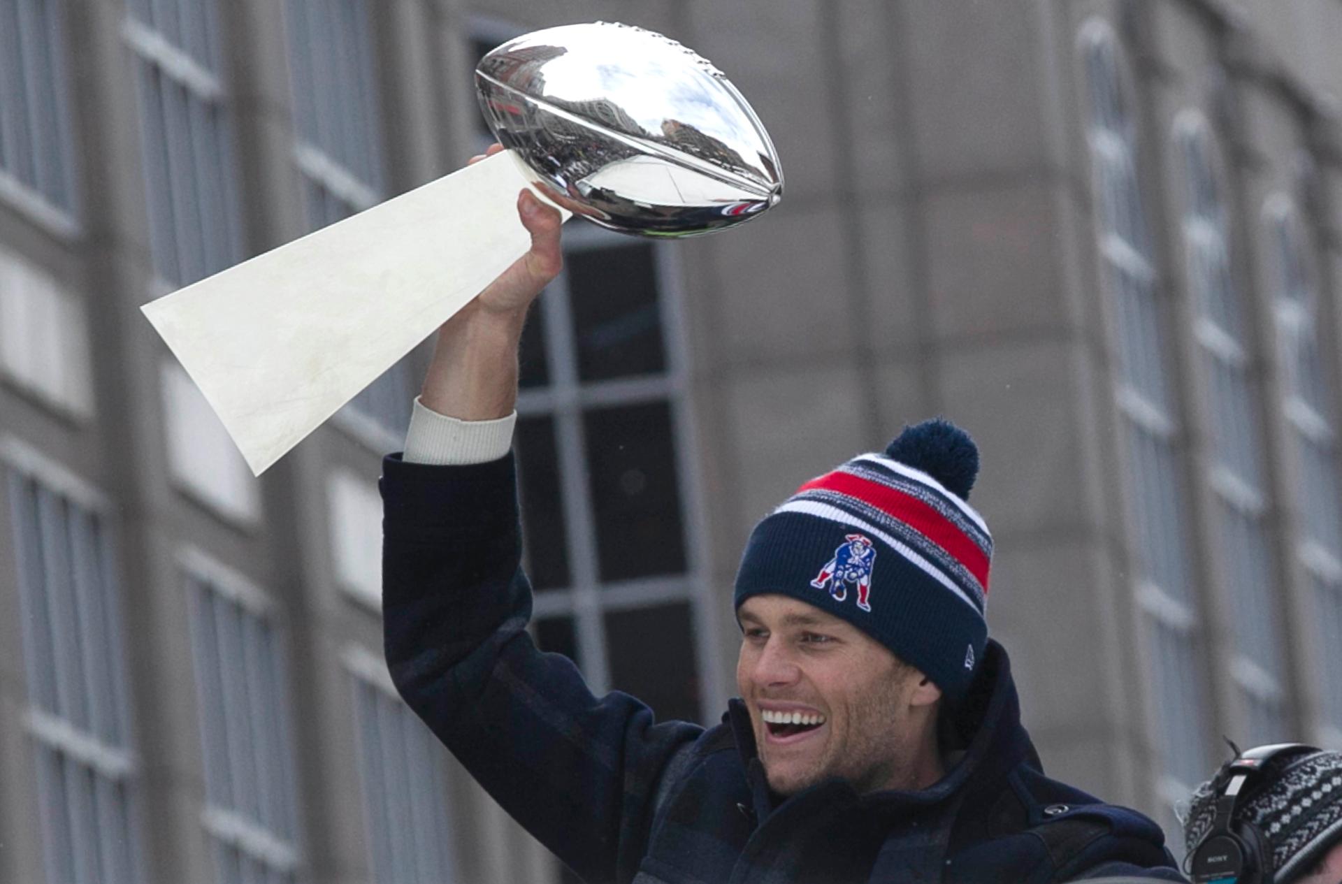 New England Patriots quarterback and Super Bowl MVP Tom Brady, holds the Vince Lombardi trophy during the Patriots' Super Bowl XLIX victory parade in Boston on February 4, 2015.