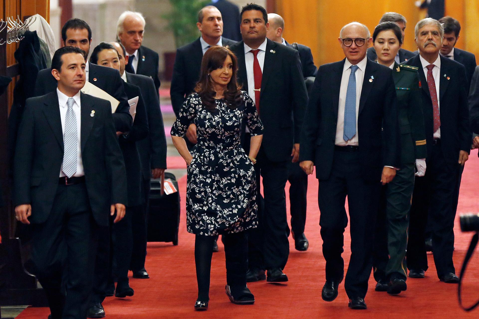 Argentina's President Cristina Fernandez de Kirchner  walks on the carpet before a meeting at the Great Hall of the People in Beijing February 5, 2015.