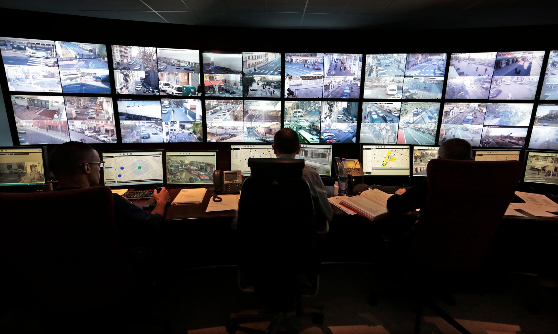Municipal police officers watch screens in the video surveillance control room of the municipal police supervision centre in Nice February 9, 2015.