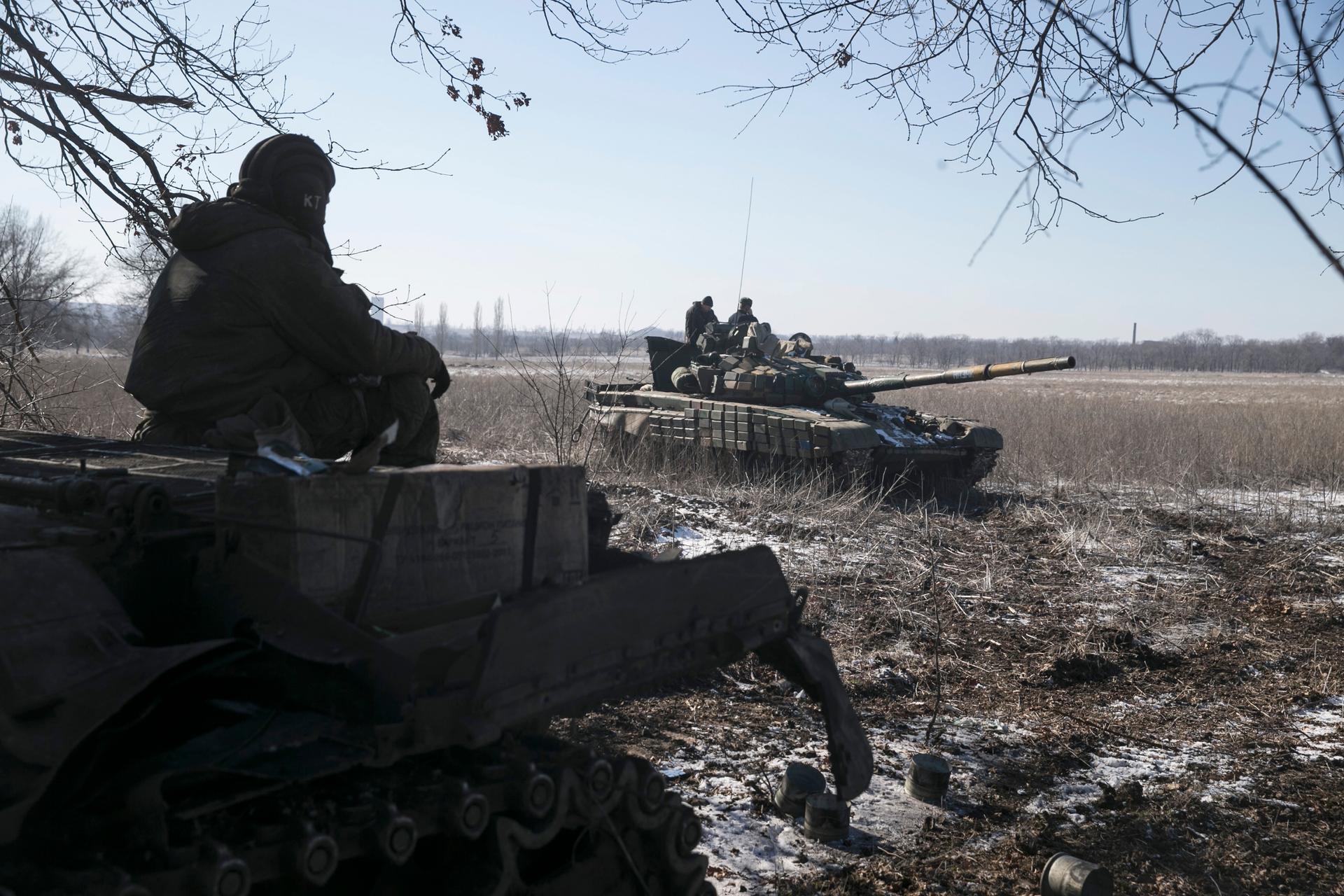 A member of a tank crew from the self-proclaimed Donetsk People's Republic Army sits on top of a tank at a checkpoint on the road from the town of Vuhlehirsk to Debaltseve on February 18, 2015.