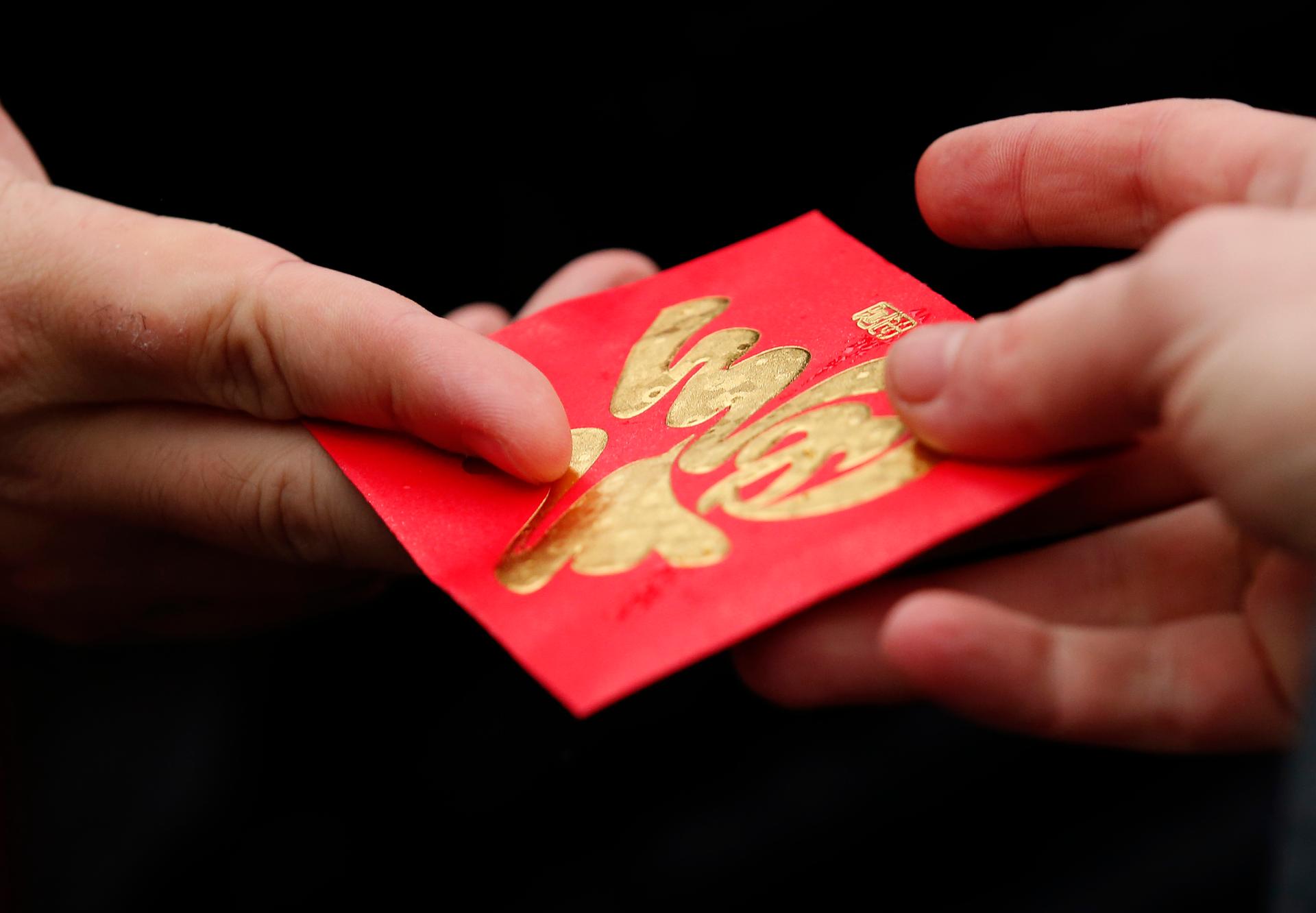 A red envelope is given out during Chinese Lunar New Year celebrations in Liverpool, England, on February 22, 2015.