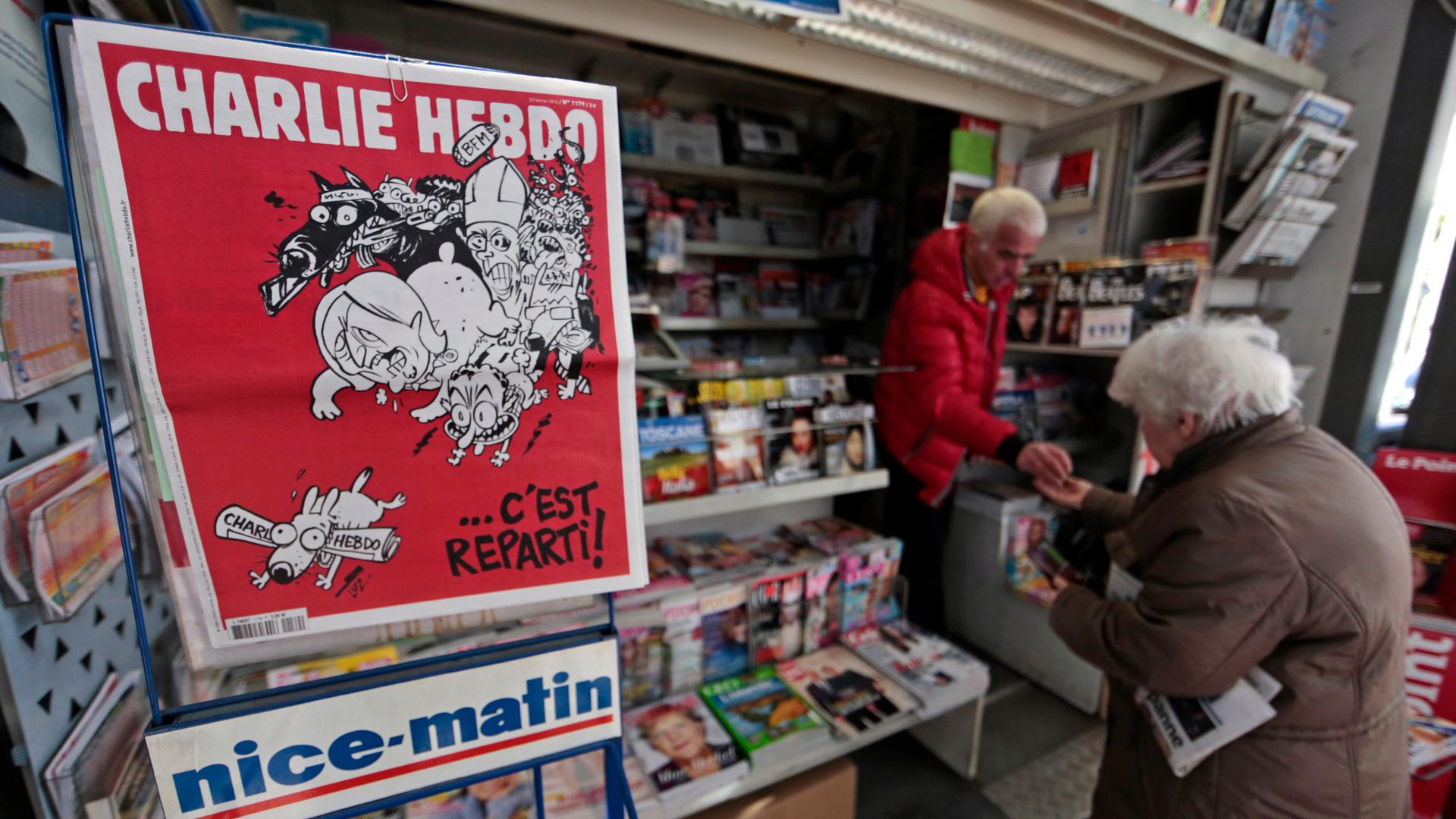 The front page of satirical French weekly Charlie Hebdo, entitled "C'est Reparti" ("Here we go again") is displayed at a kiosk in Nice on February 25, 2015.