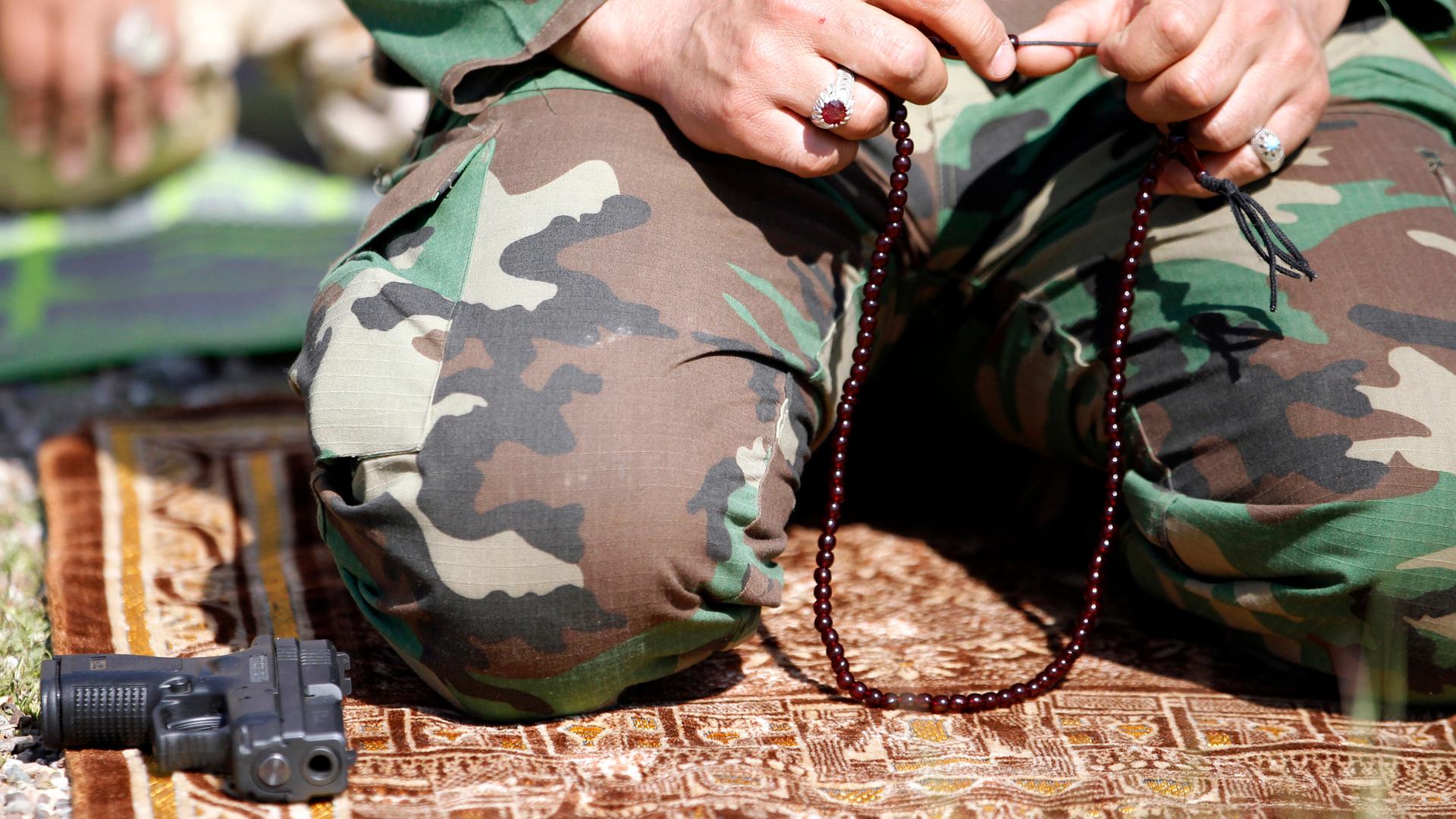 A Shi’ite militiaman praying before the battle for Tikrit commenced on March 1, 2015.