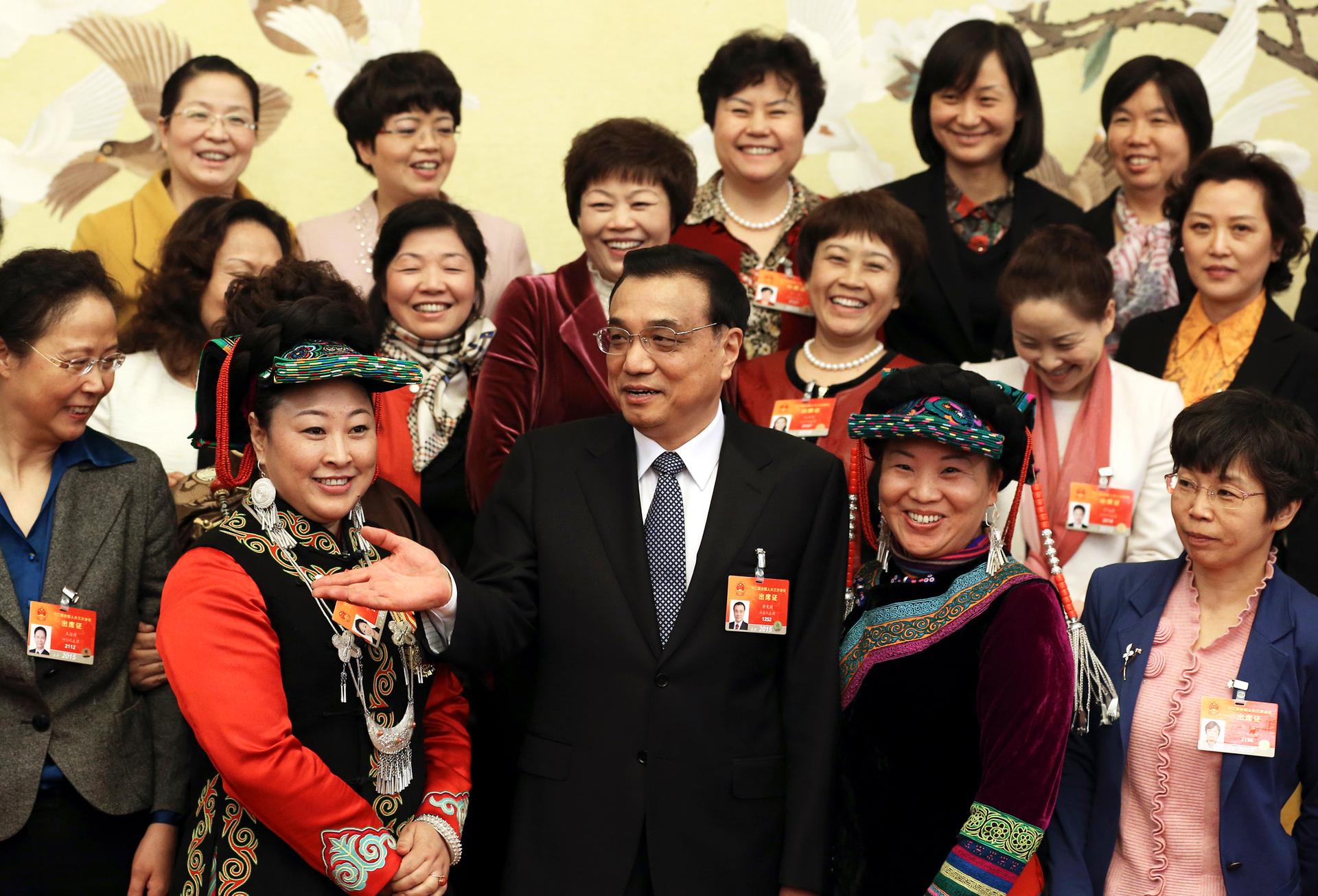Chinese Premier Li Keqiang (C) poses with female delegates at the annual session of the National People's Congress (NPC) on International Women's Day in Beijing on March 8, 2015.