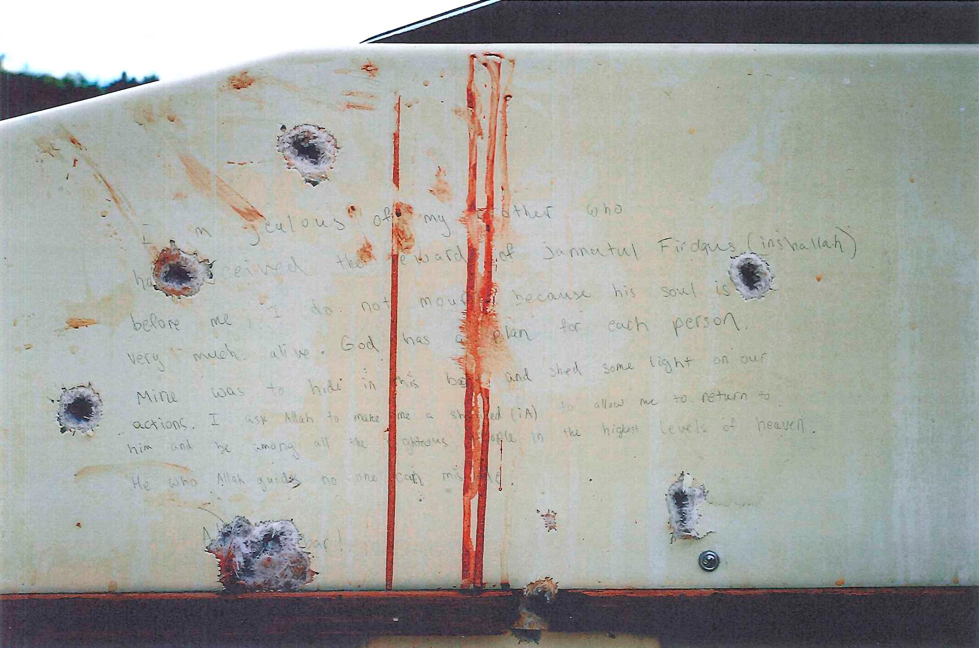 A blood-stained message prosecutors say Boston Marathon bomber Dzhokhar Tsarnaev wrote on the inside of a boat. The undated photo was presented as evidence to jurors at Tsarnaev's trial in Boston.