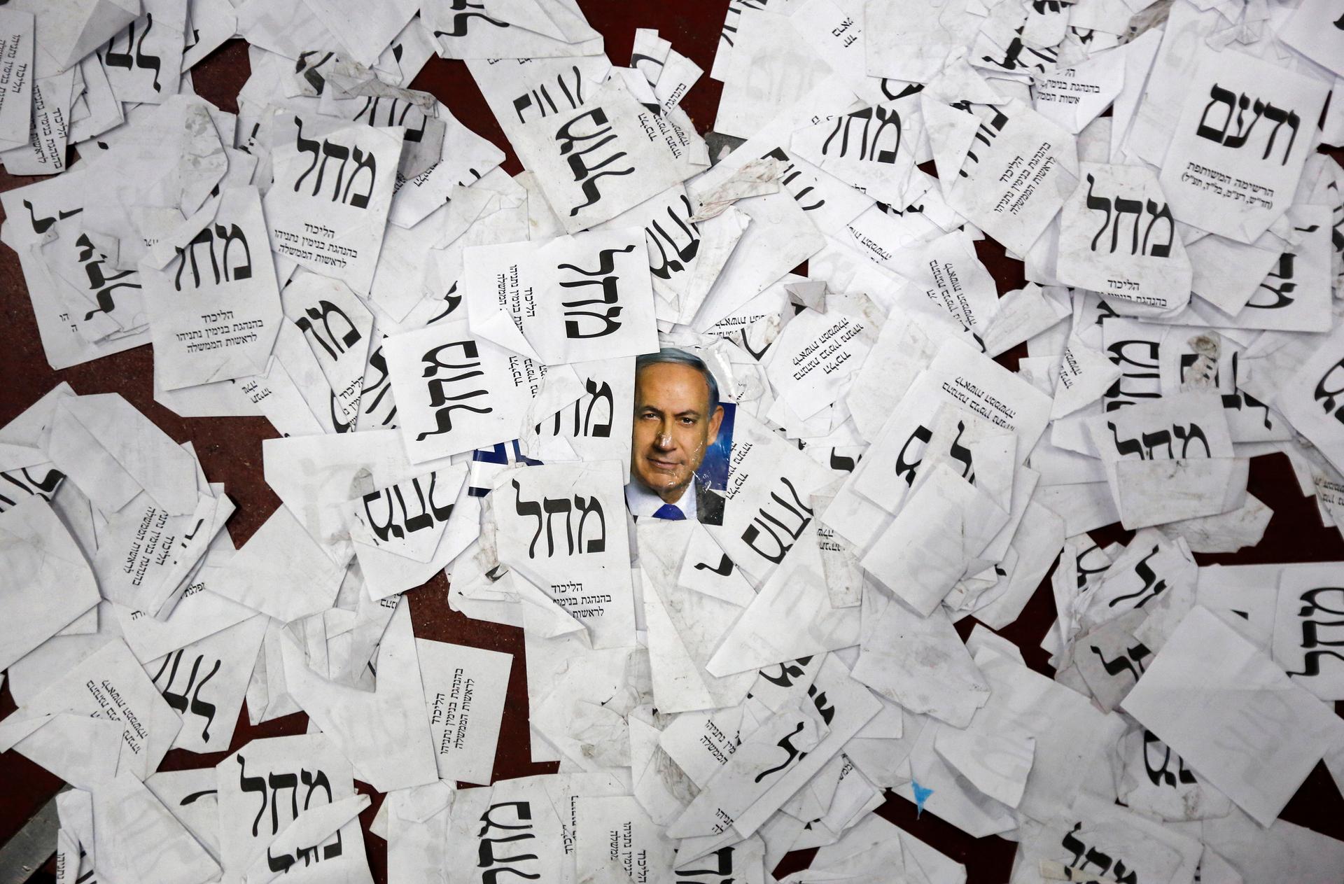 A photograph of Israeli Prime Minister Benjamin Netanyahu is seen on the floor with Likud party ballots at Likud party headquarters in Tel Aviv March 18, 2015.