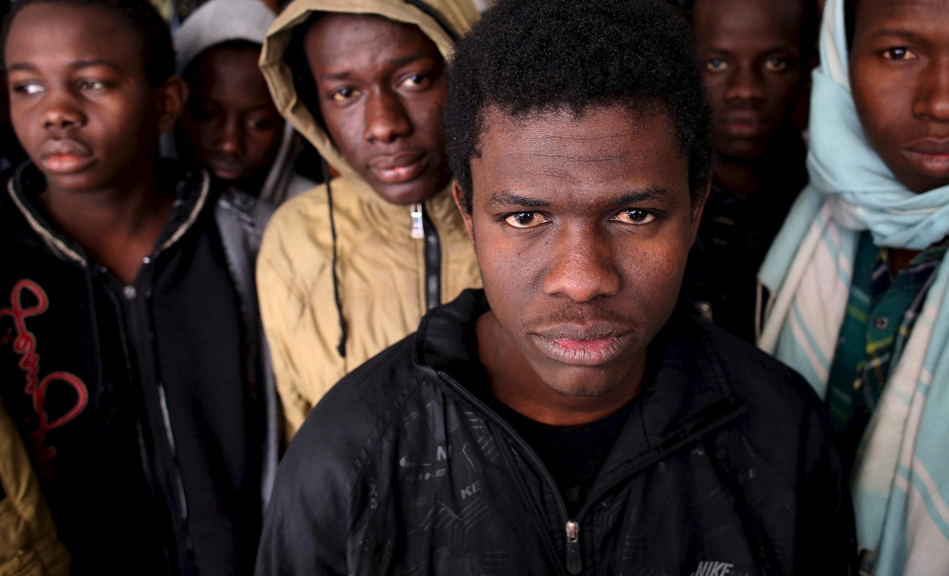 Illegal migrants stand in an immigration holding centre located on the outskirts of Misrata Libya, on March 11, 2015. Italy wants Egypt and Tunisia to play a role in rescuing stricken migrant vessels in the Mediterranean.