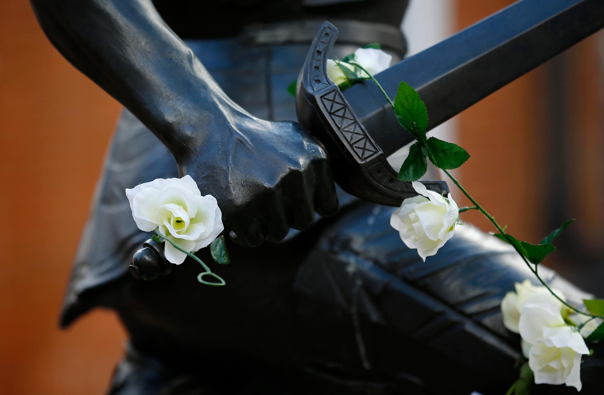 White roses adorn the King Richard III statue at Leicester Cathedral in central England.