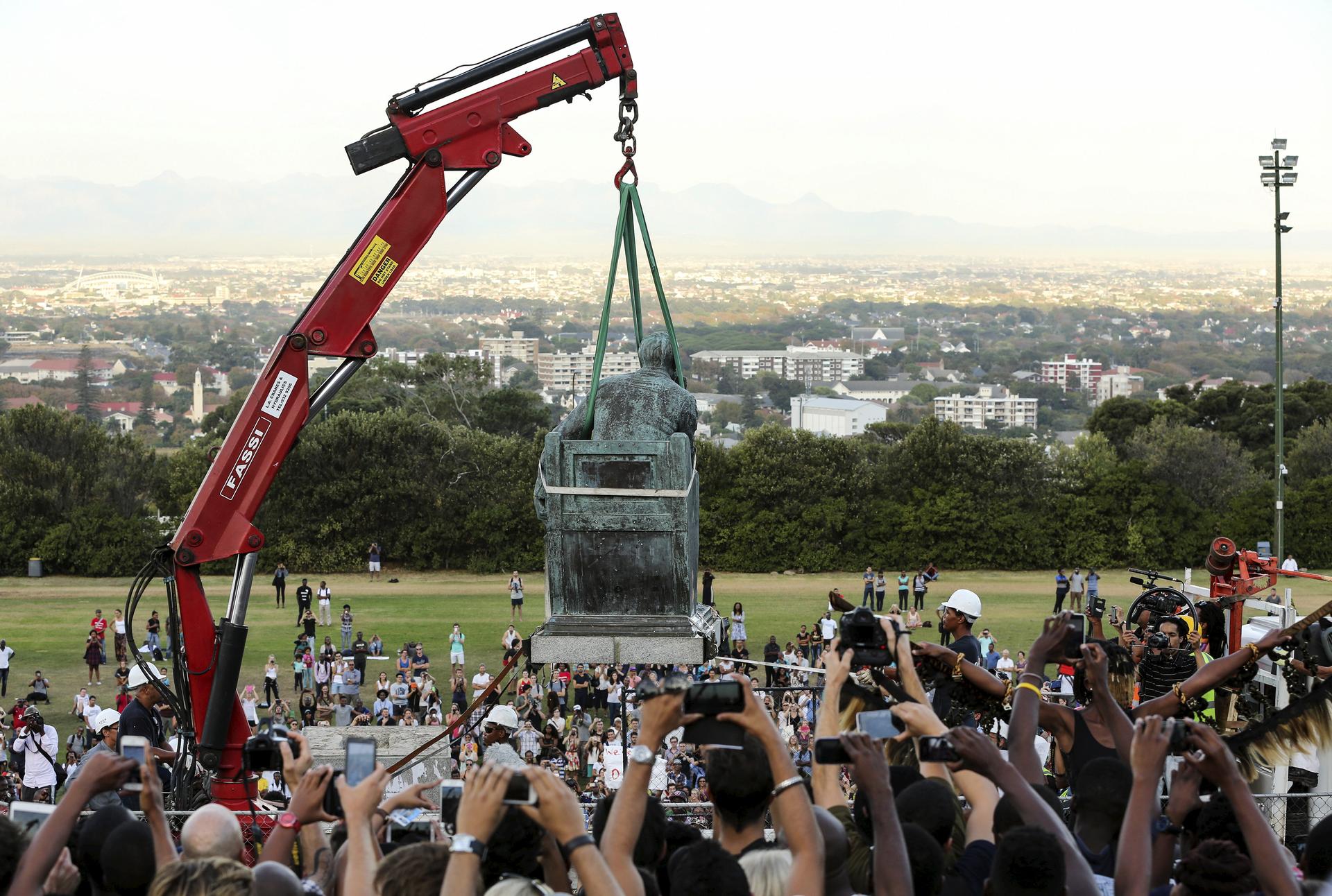 Students cheer as the statue of Cecil John Rhodes is removed from the University of Cape Town (UCT), April 9, 2015. 