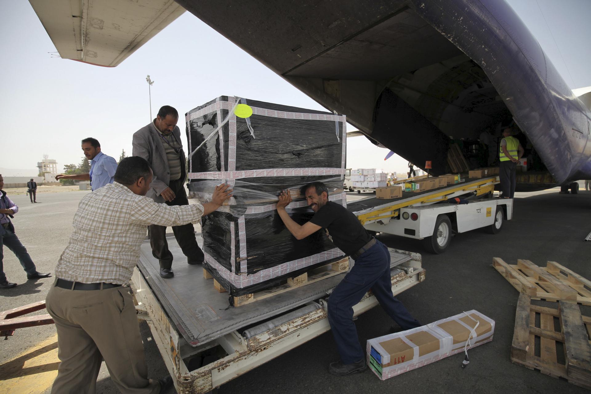 Workers unload emergency medical aid from Medecins Sans Frontieres from a plane at Sanaa airport on April 13, 2015