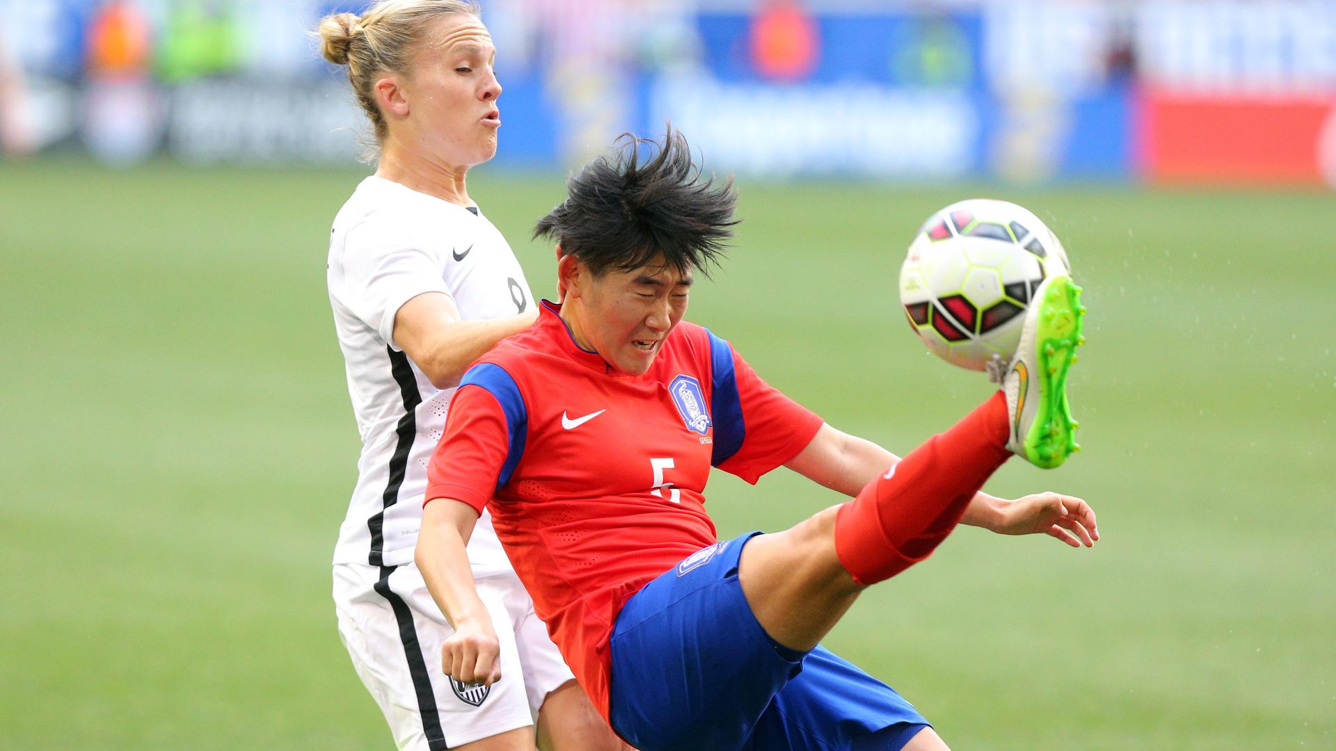 Korea defender Kim Sooyun (5) kicks the ball against USA forward Amy Rodriguez (8) during the second half at Red Bull Arena.