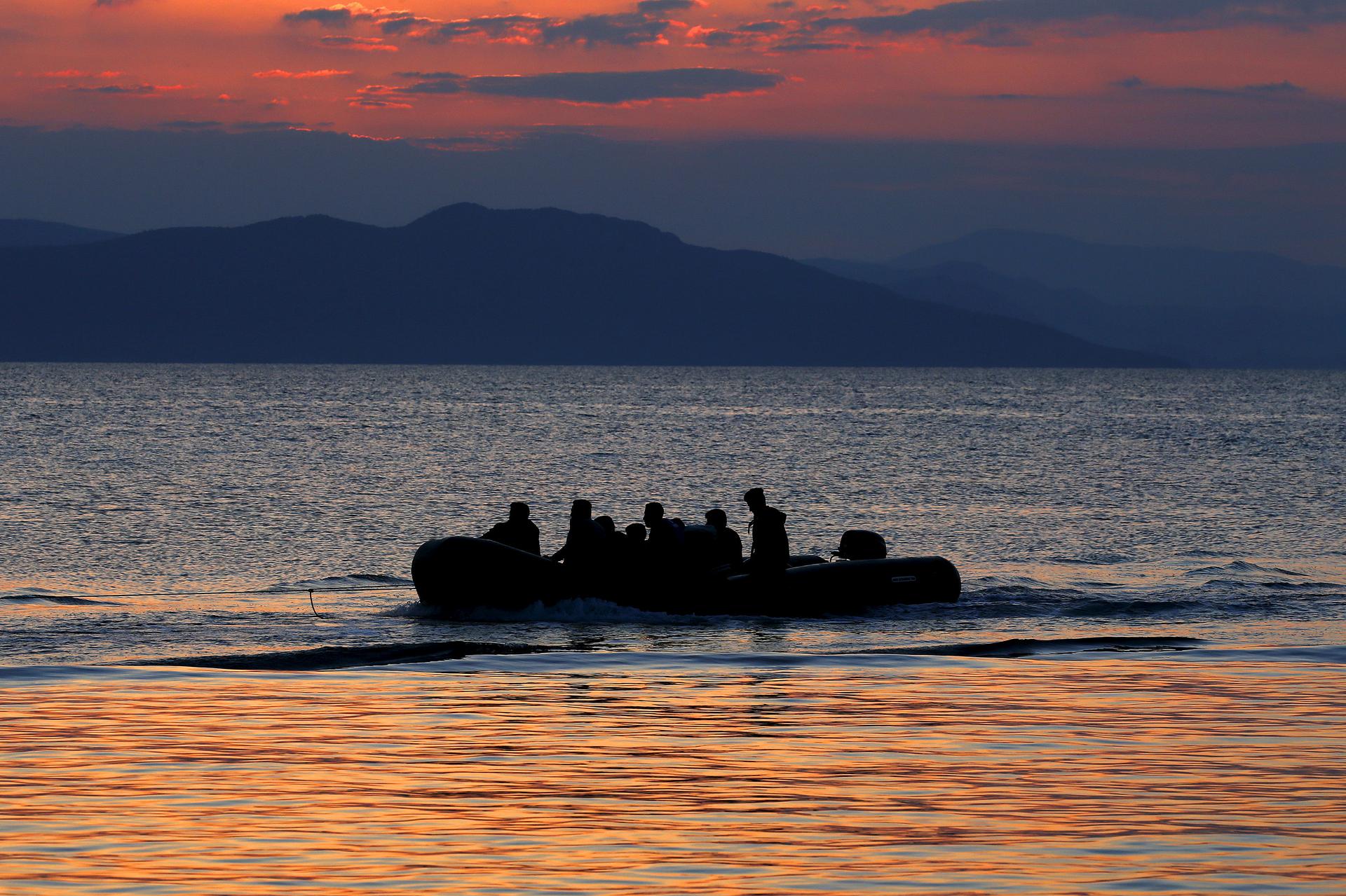 A dinghy with Syrian refugees is towed by a Greek coast guard patrol boat into the port on the Greek island of Kos, following a rescue operation in a part of the Aegean Sea between Turkey and Greece, early May 31, 2015.