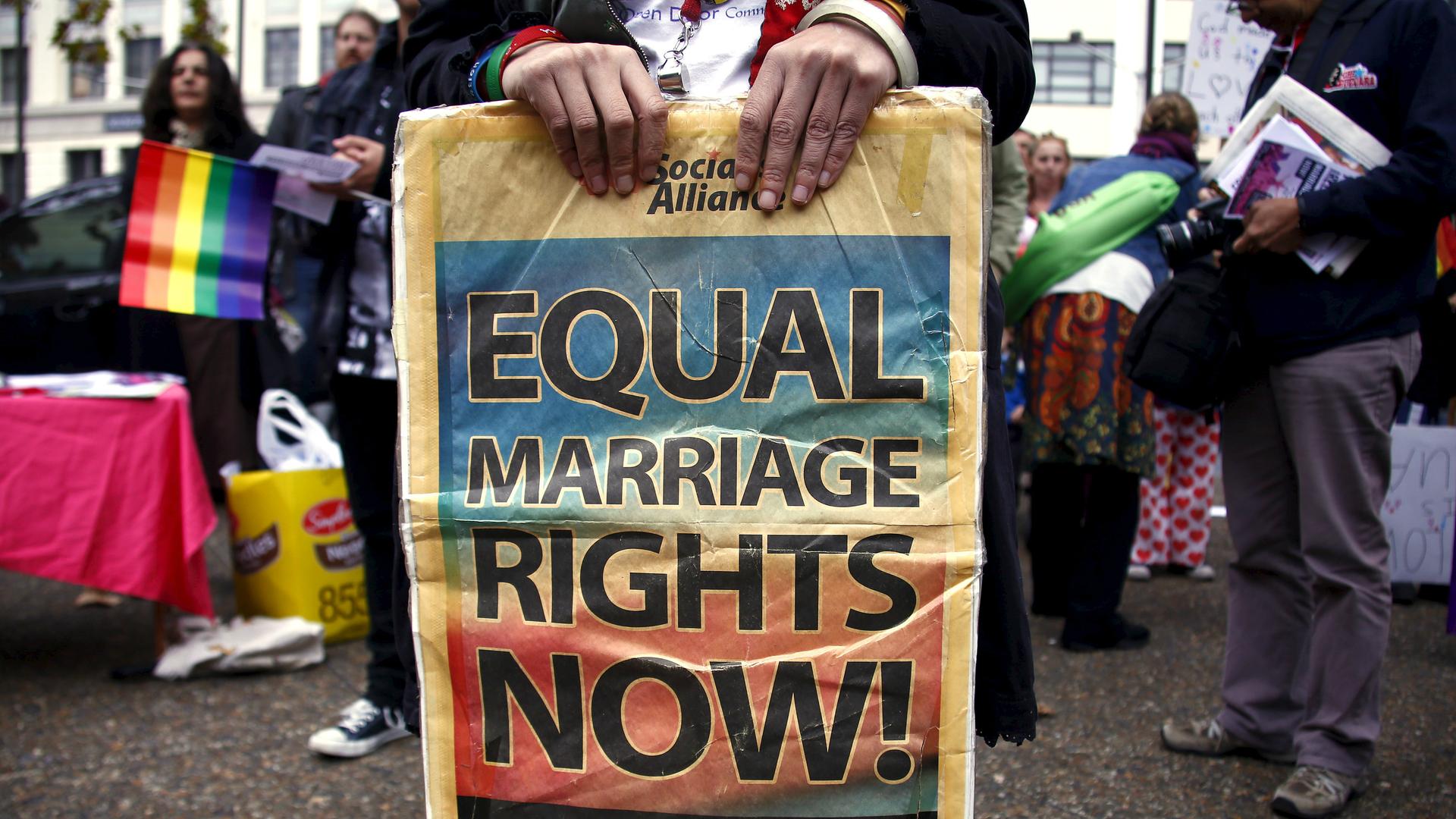 A gay rights activist holds a placard during a rally supporting same-sex marriage, in Sydney, Australia, May 31, 2015. 