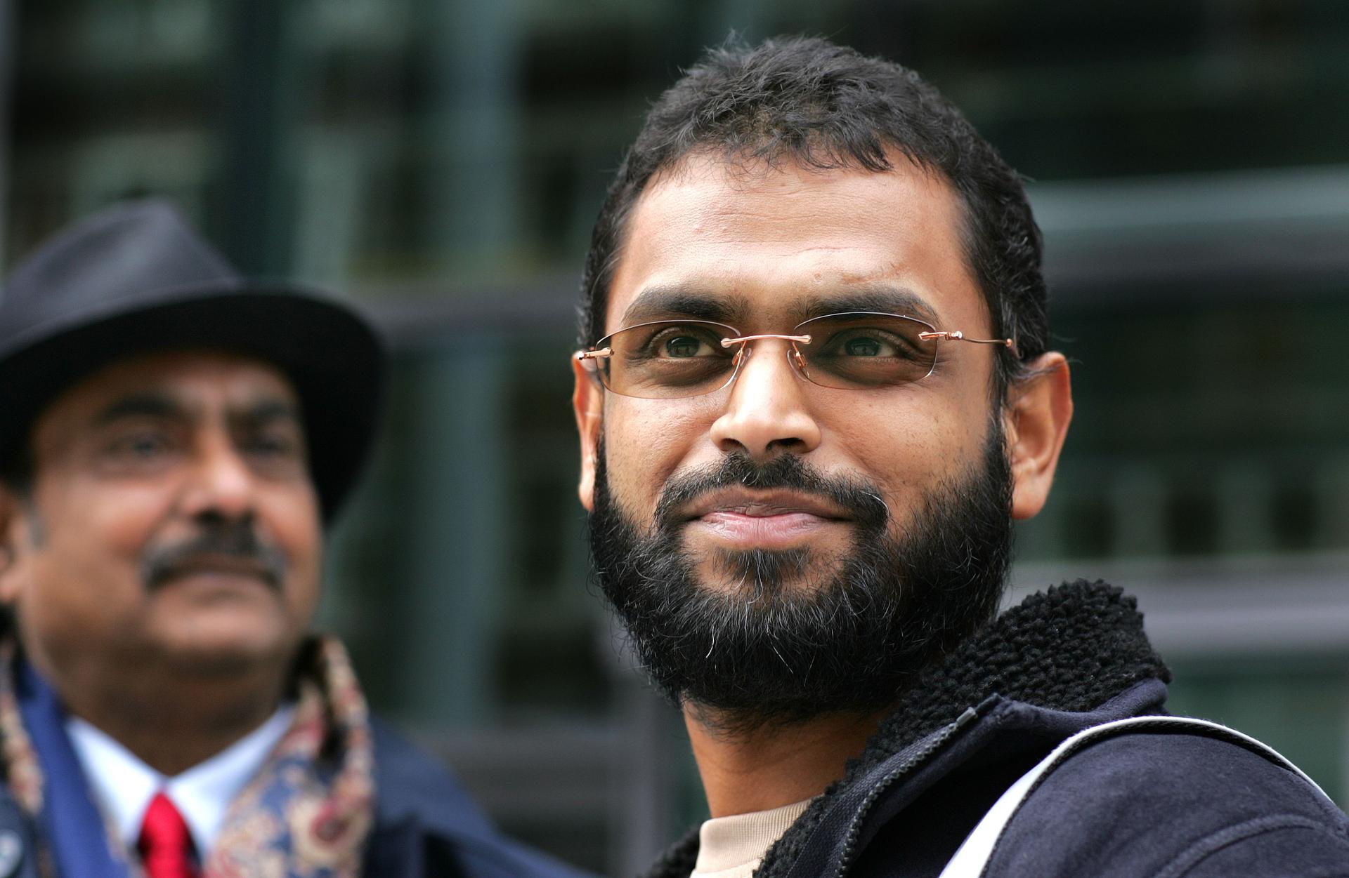 Freed Guantanamo Bay detainee Moazzam Begg stands outside the Home Office with his father, Azmat, after delivering a petition in London on March 14, 2005.
