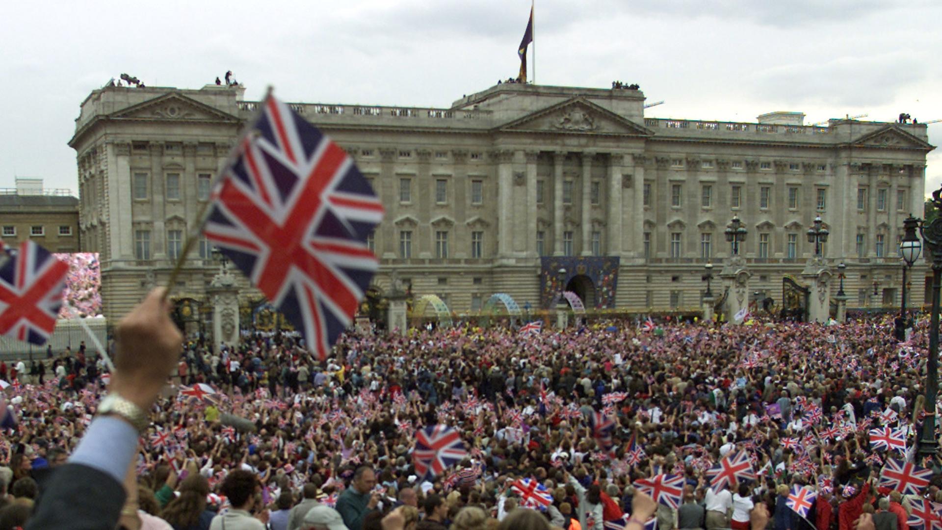 Thousands wave flags and sing ‘Land Of Hope And Glory’ outside Buckingham Palace in London during celebrations of Queen Elizabeth's 50th year on the throne, in 2002.  