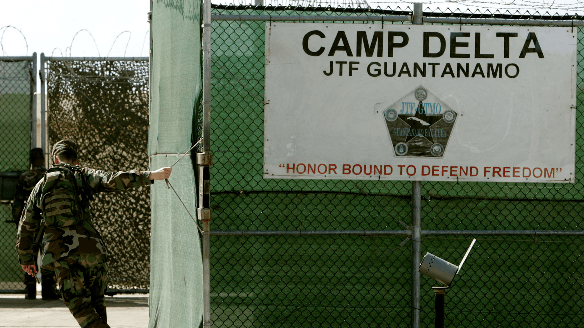 Soldier closes gate as military tribunals continue At Guantanamo Bay.
