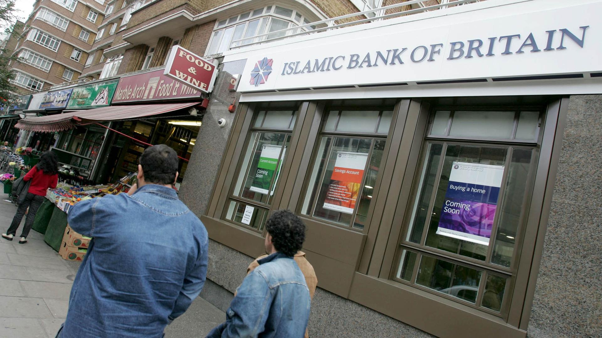 People walk past Islamic Bank of Britain's (IBB) first branch on Edgware Road in London.