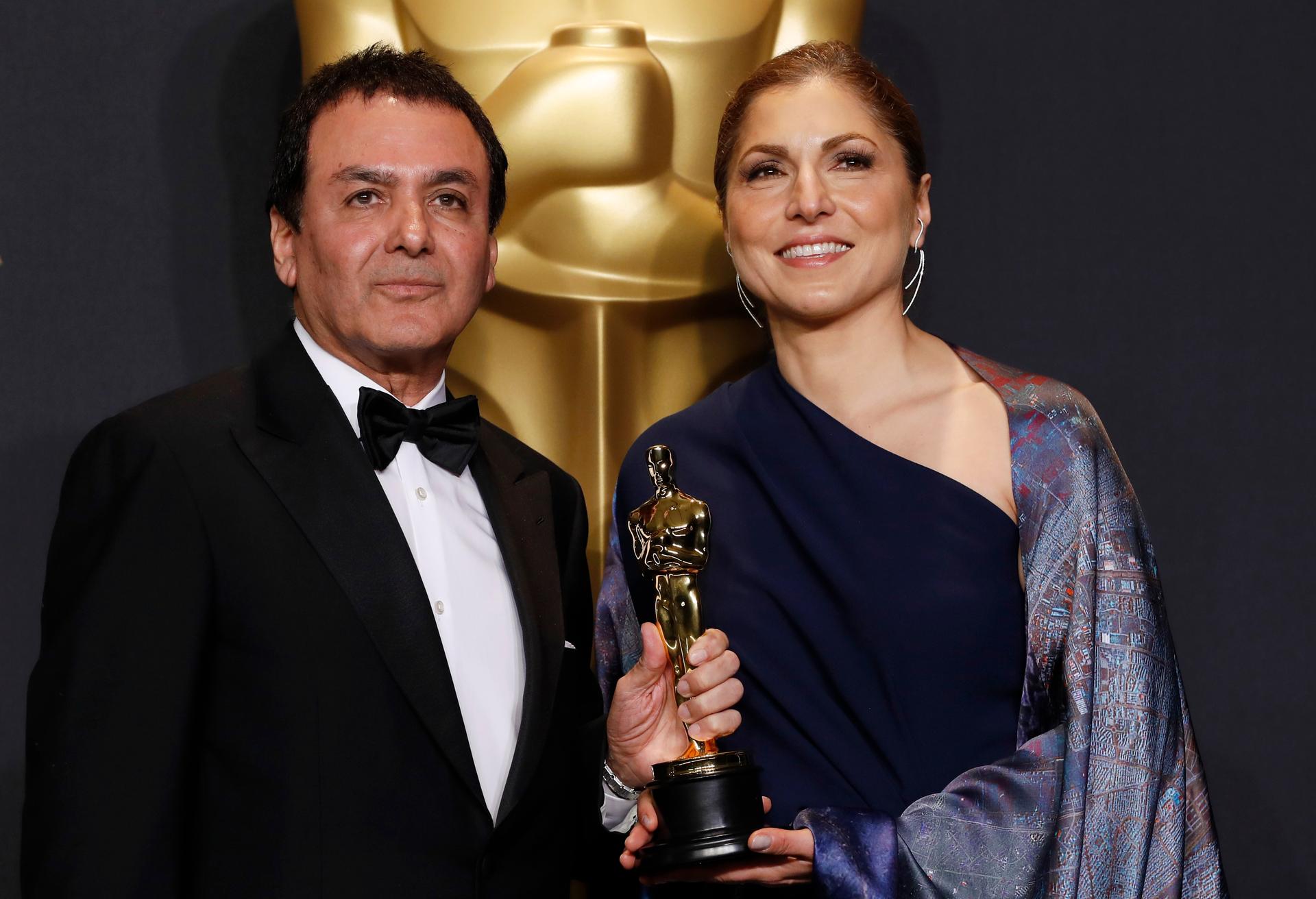 Anousheh Ansari and Firouz Naderi pose with the Oscar they accepted on behalf of Asghar Farhadi, who won the Best Foreign Language Film for "The Salesman". 