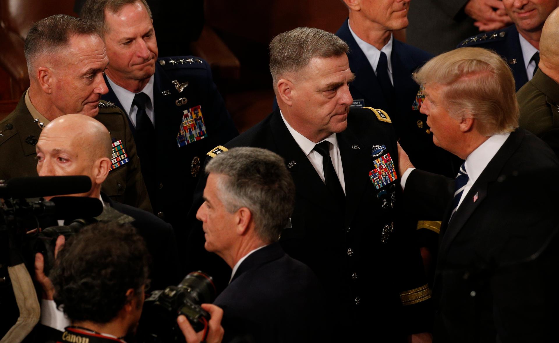 President Donald Trump talks to members of the US military's Joint Chiefs of Staff