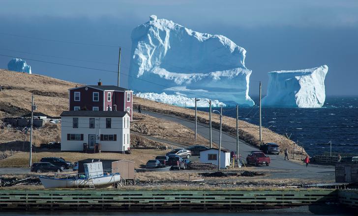 Residents view the first iceberg of the season as it passes the South Shore, also known as "Iceberg Alley", near Ferryland Newfoundland, Canada April 16, 2017.
