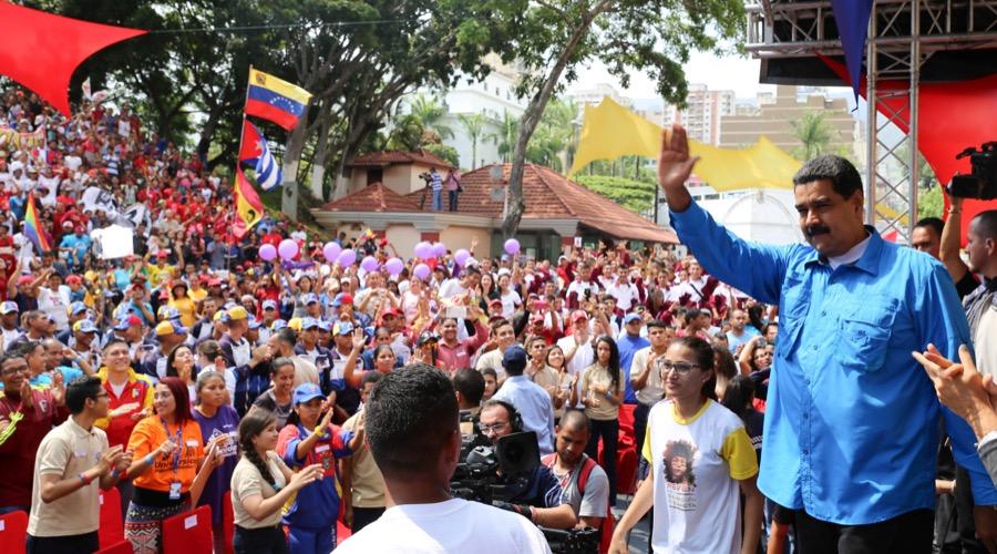 Venezuela's President Nicolas Maduro greets supporters during a meeting at Miraflores Palace in Caracas, Venezuela