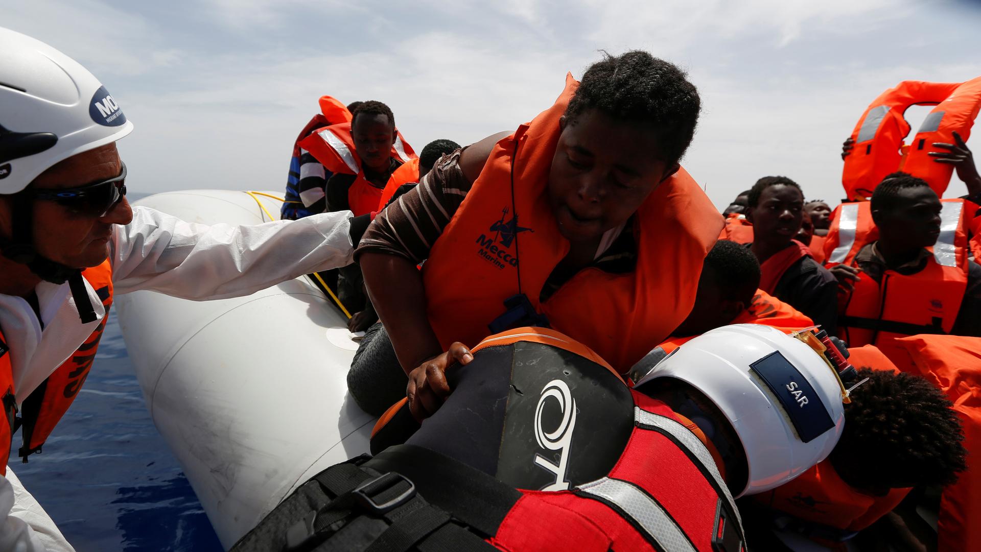 Migrant Offshore Aid Station rescues migrants from a rubber dinghy during an operation in the central Mediterranean