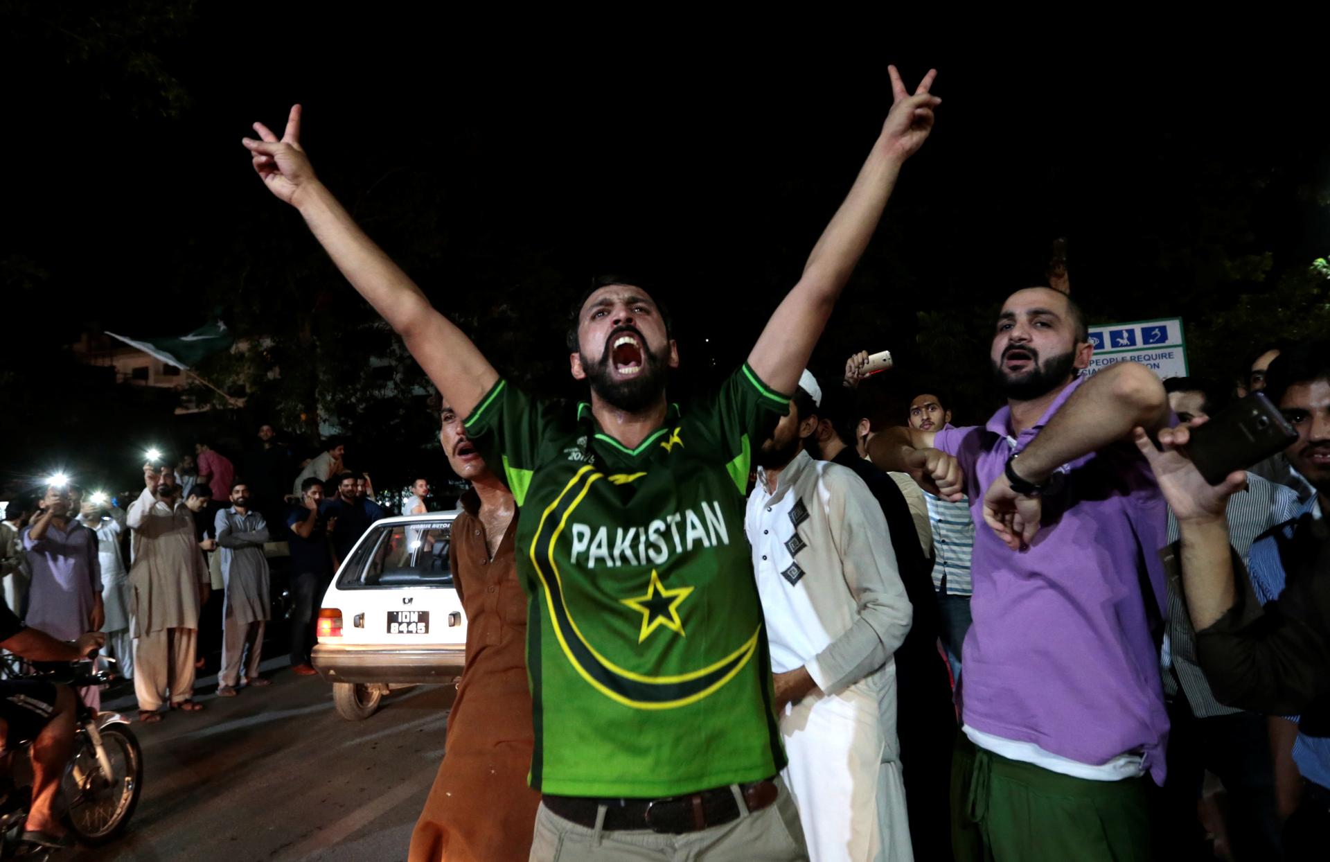 Pakistani cricket fans, in Islamabad, cheer after Pakistan defeated India in the Champions Trophy finals