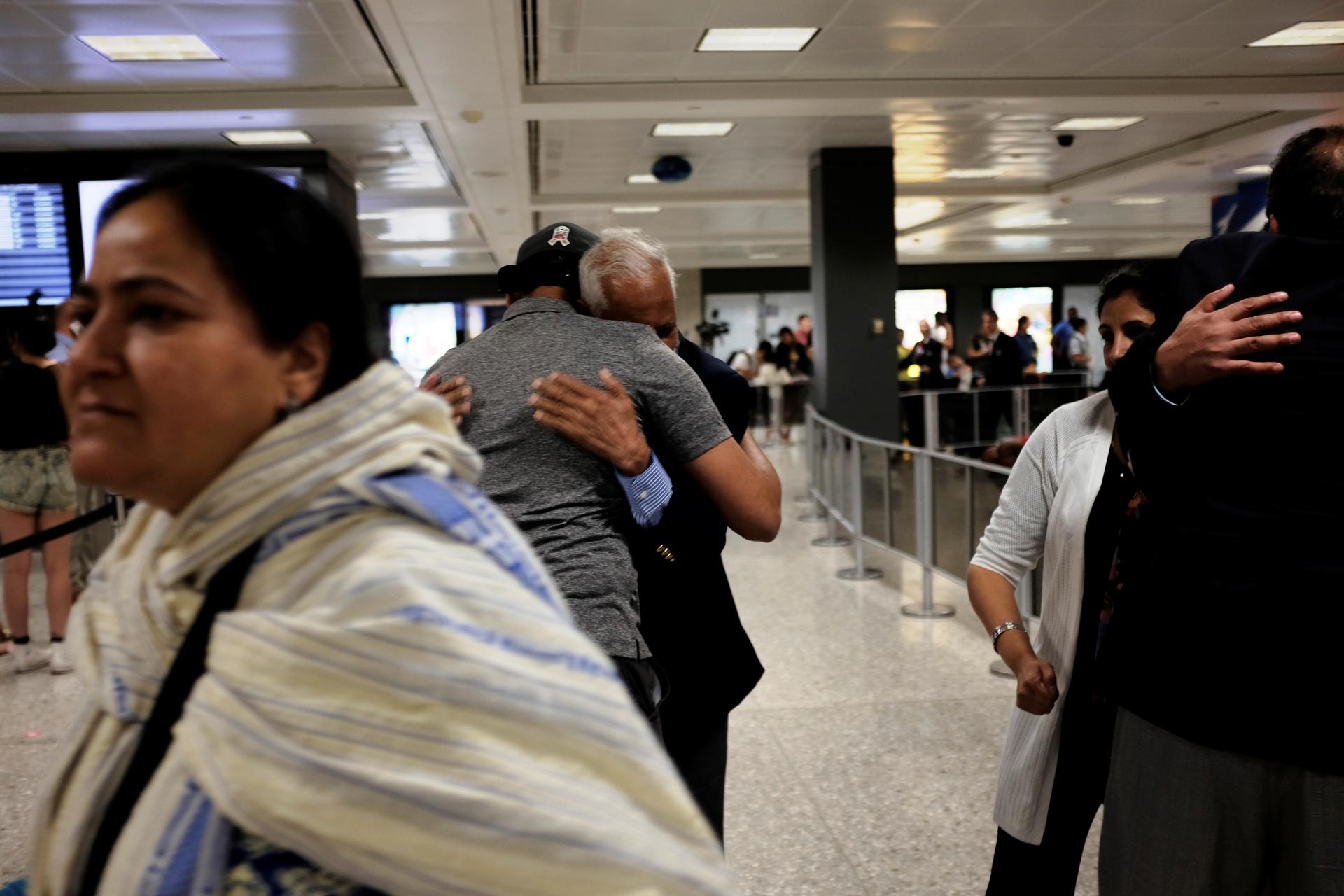 International passengers embrace family members as they arrive at Washington Dulles International Airport after the Trump administration's travel ban was allowed back into effect pending further judicial review, in Dulles, Virginia, U.S., June 29, 2017.