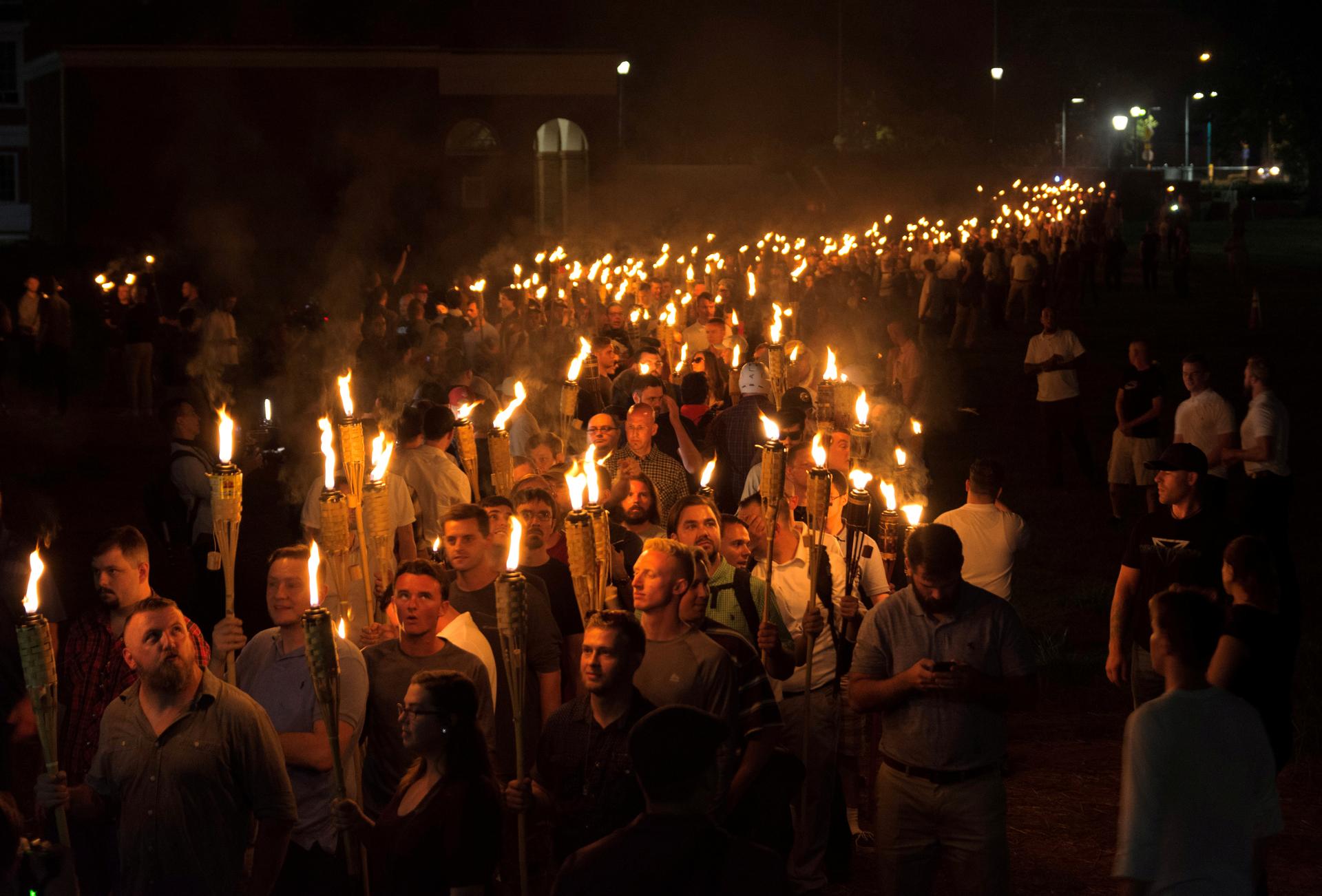 White nationalists carry torches on the grounds of the University of Virginia, on the eve of a planned Unite The Right rally in Charlottesville, Virginia, US August 11, 2017. Picture taken August 11, 2017. 