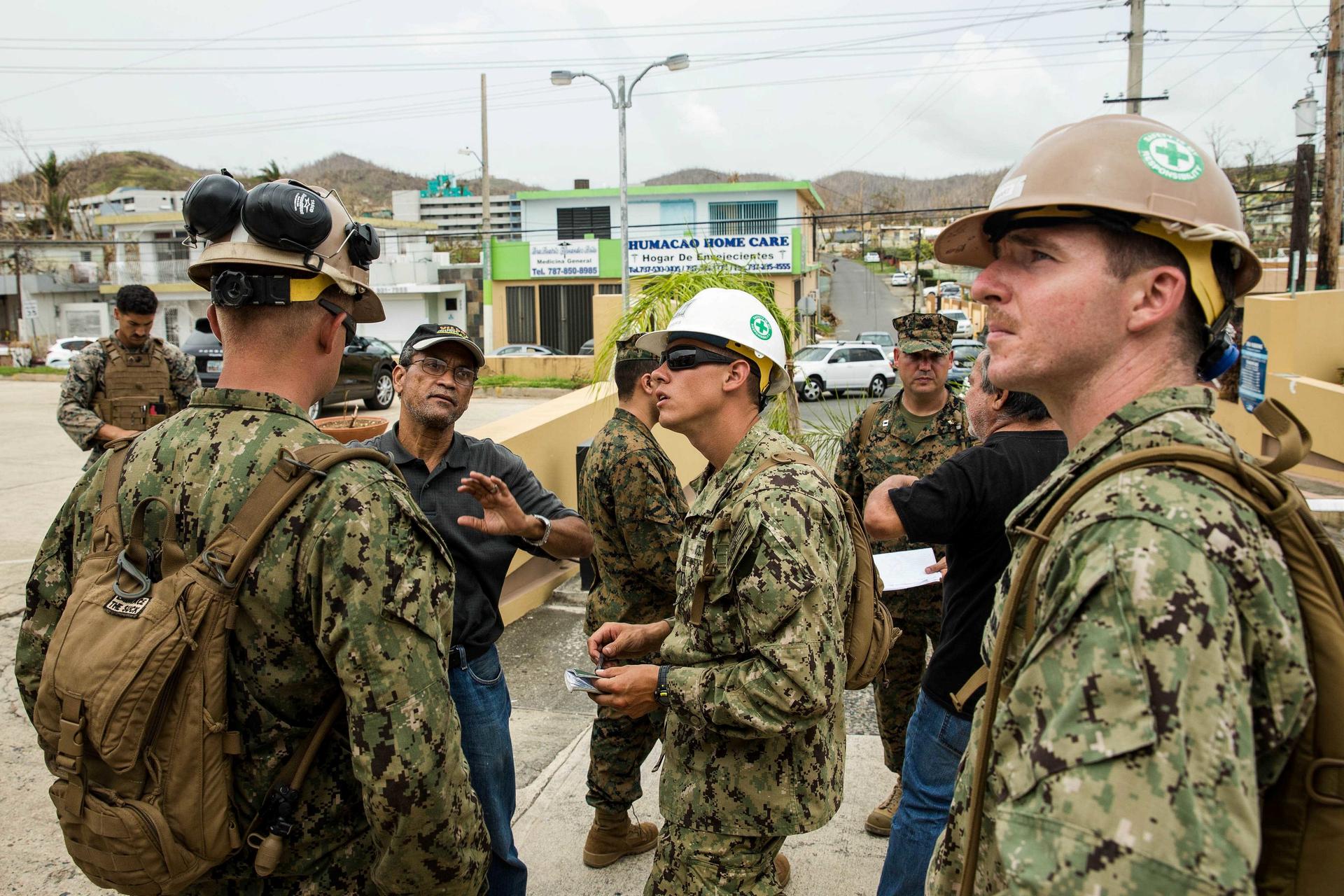 U.S. Marines and Navy corpsmen attached to the 26th Marine Expeditionary Unit and Sailors assigned to Amphibious Construction Battalion 2 speak with local civilian employees during an assessment of Hospital Oriente’s medical and operational needs as part 