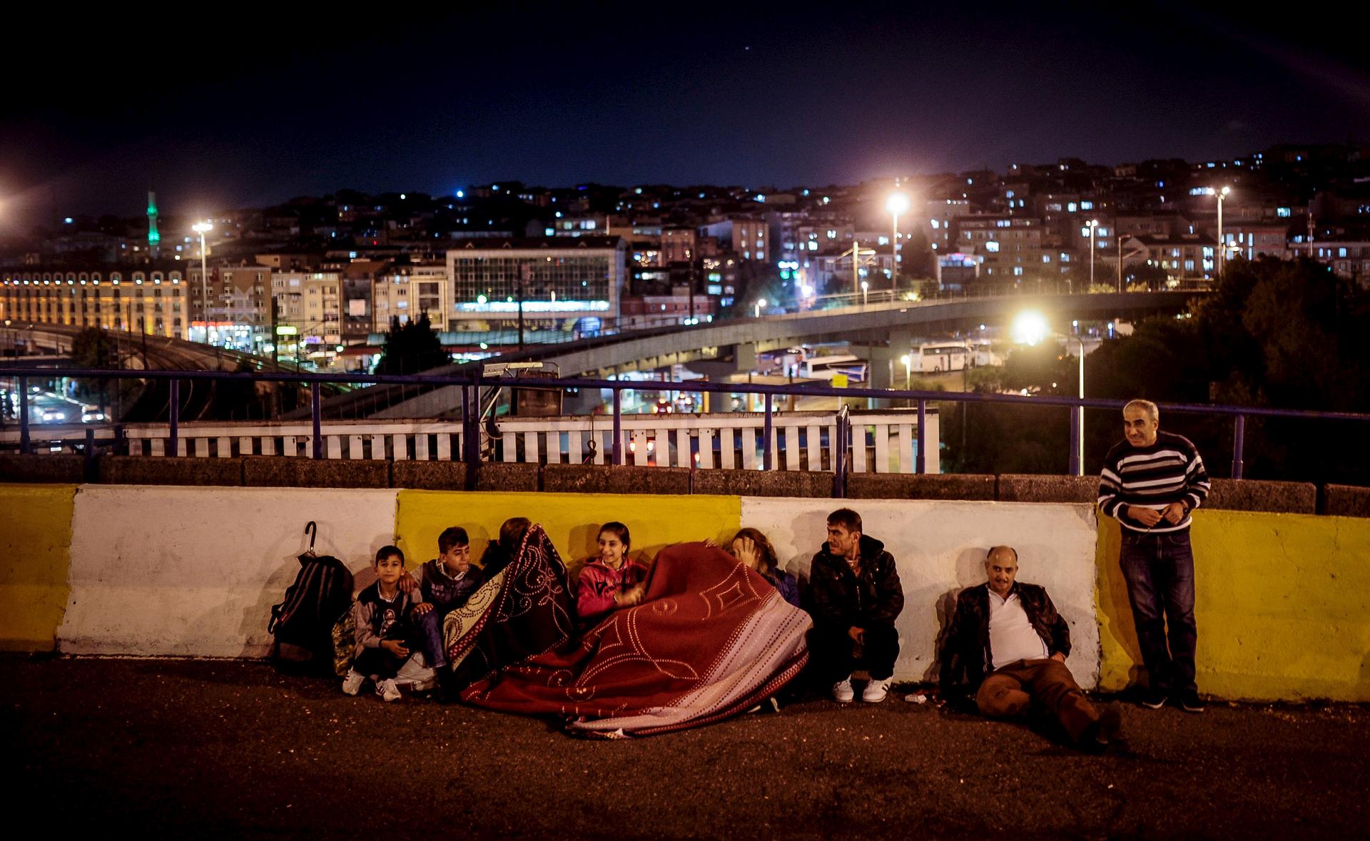 A migrant family spends the night near the main bus station in Istanbul on Sept. 17, 2015.