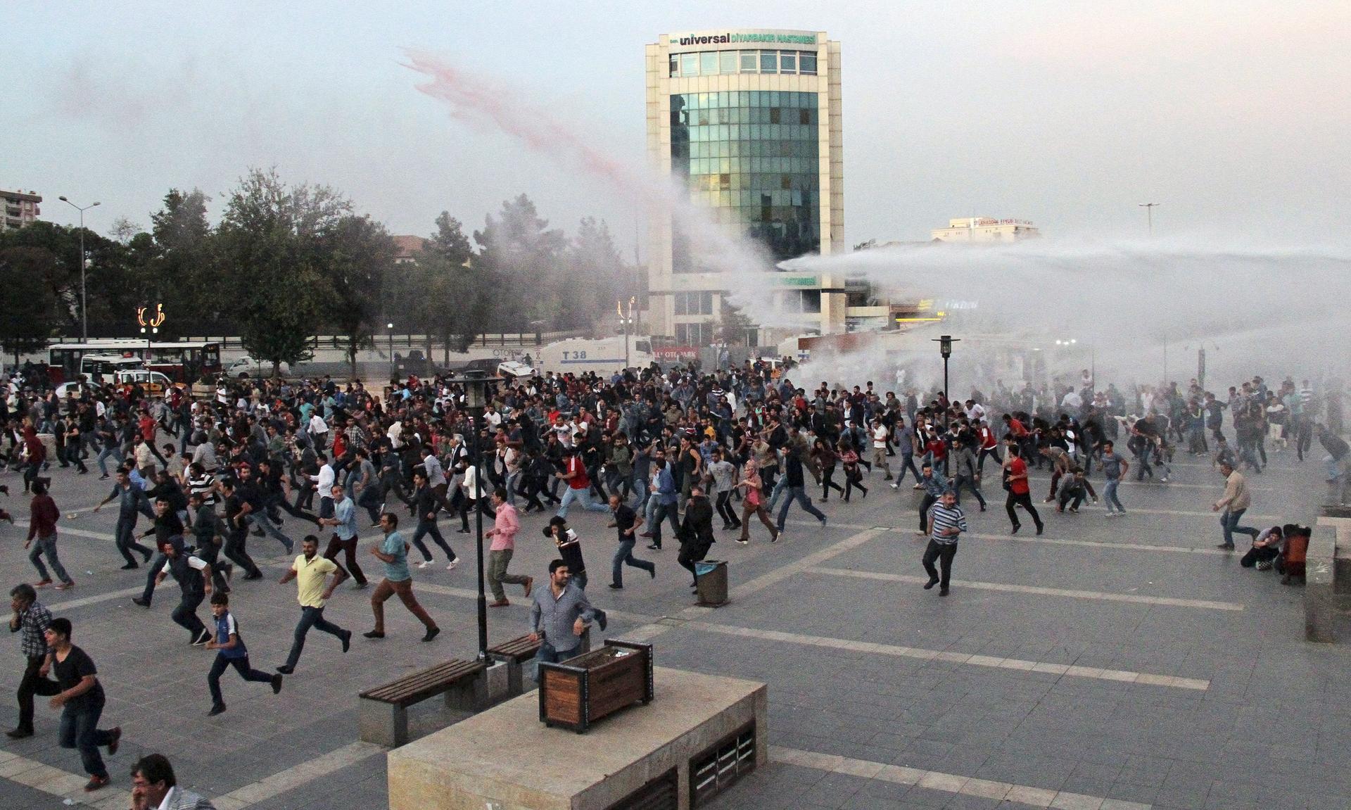 Police in Diyarbakir, Turkey, on October 11, 2015 use tear gas and water cannon to disperse people marching to protest the double suicide bombing in Ankara that killed up to 128 people.