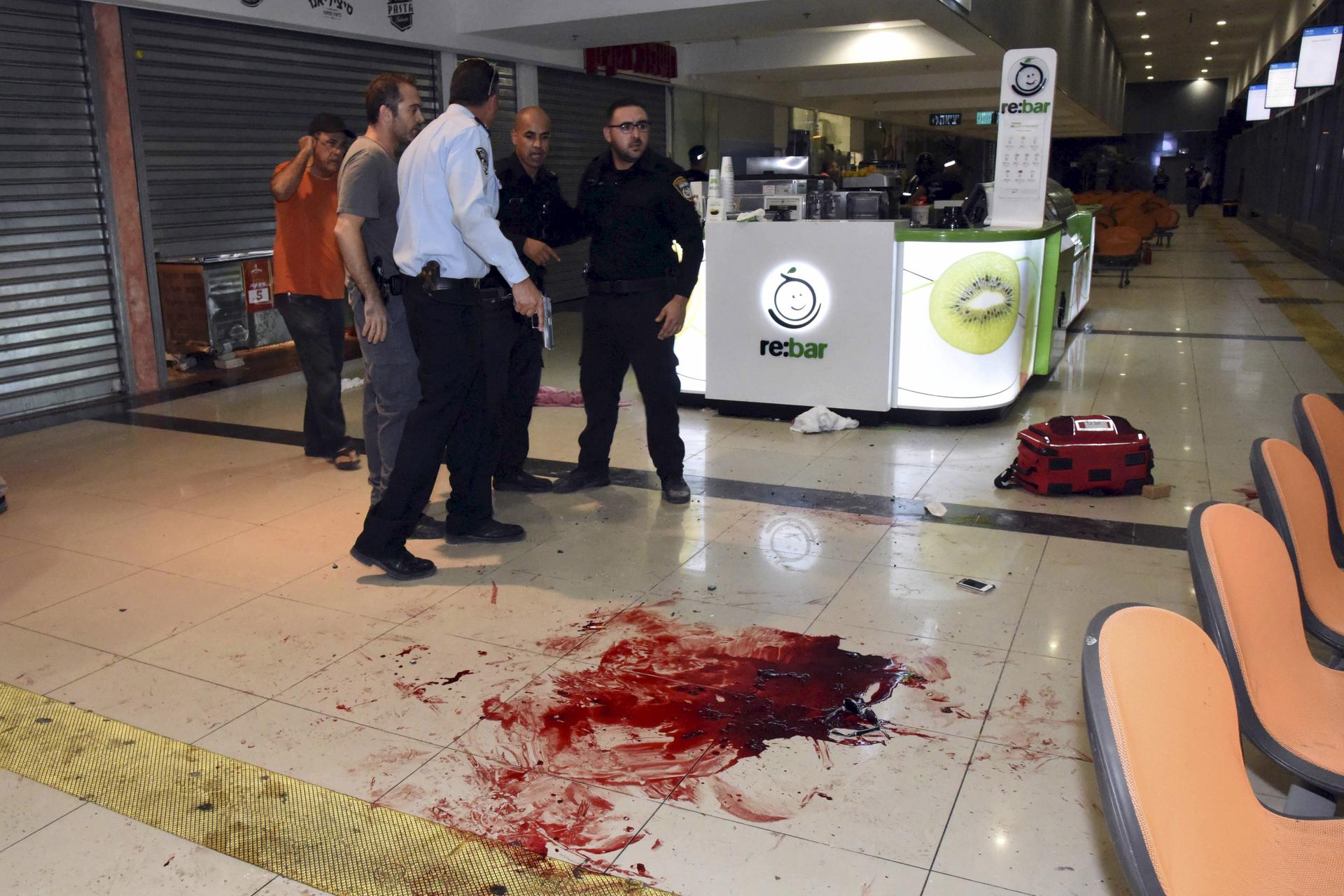 Israeli security personals stand next to blood on the floor, at the Beersheba central bus station where a Palestinian gunman went on a stabbing and shooting rampage, followed by a mob attacking a wrongly accused bystander, October 18, 2015.