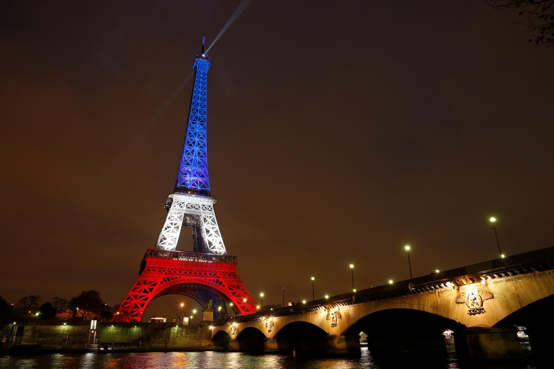 The Eiffel Tower is lit with the blue, white and red colours of the French flag in Paris, France, November 16, 2015, to pay tribute to the victims of a series of deadly attacks on Friday in the French capital.