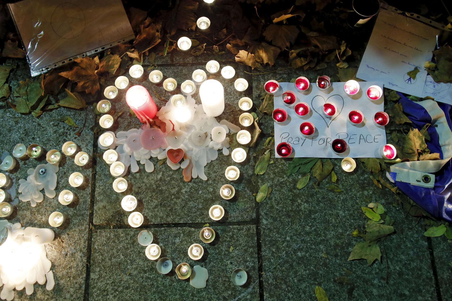 Candles burn as a tribute to victims near the site of the attack at the Bataclan concert hall in Paris in November, 2015.