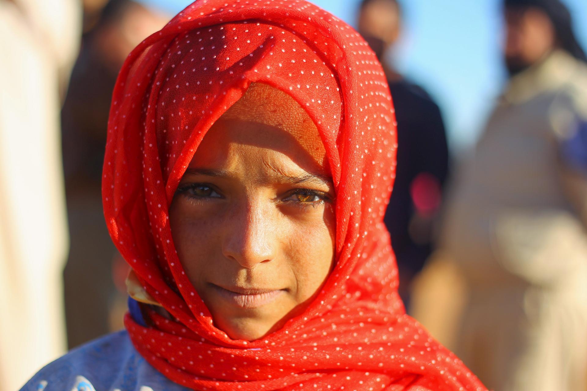An internally displaced girl poses at a makeshift refugee camp in Sinjar town, in Idlib province, Syria November 20, 2015. 