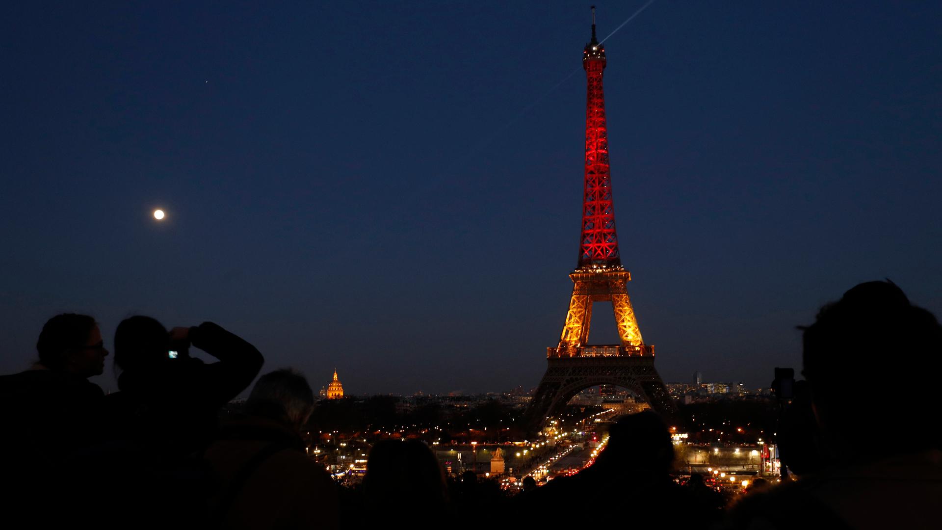 The Eiffel Tower is seen with the black, yellow and red colors of the Belgian flag in tribute to the victims of Tuesday's Brussels bomb attacks, in Paris, France, March 22, 2016.