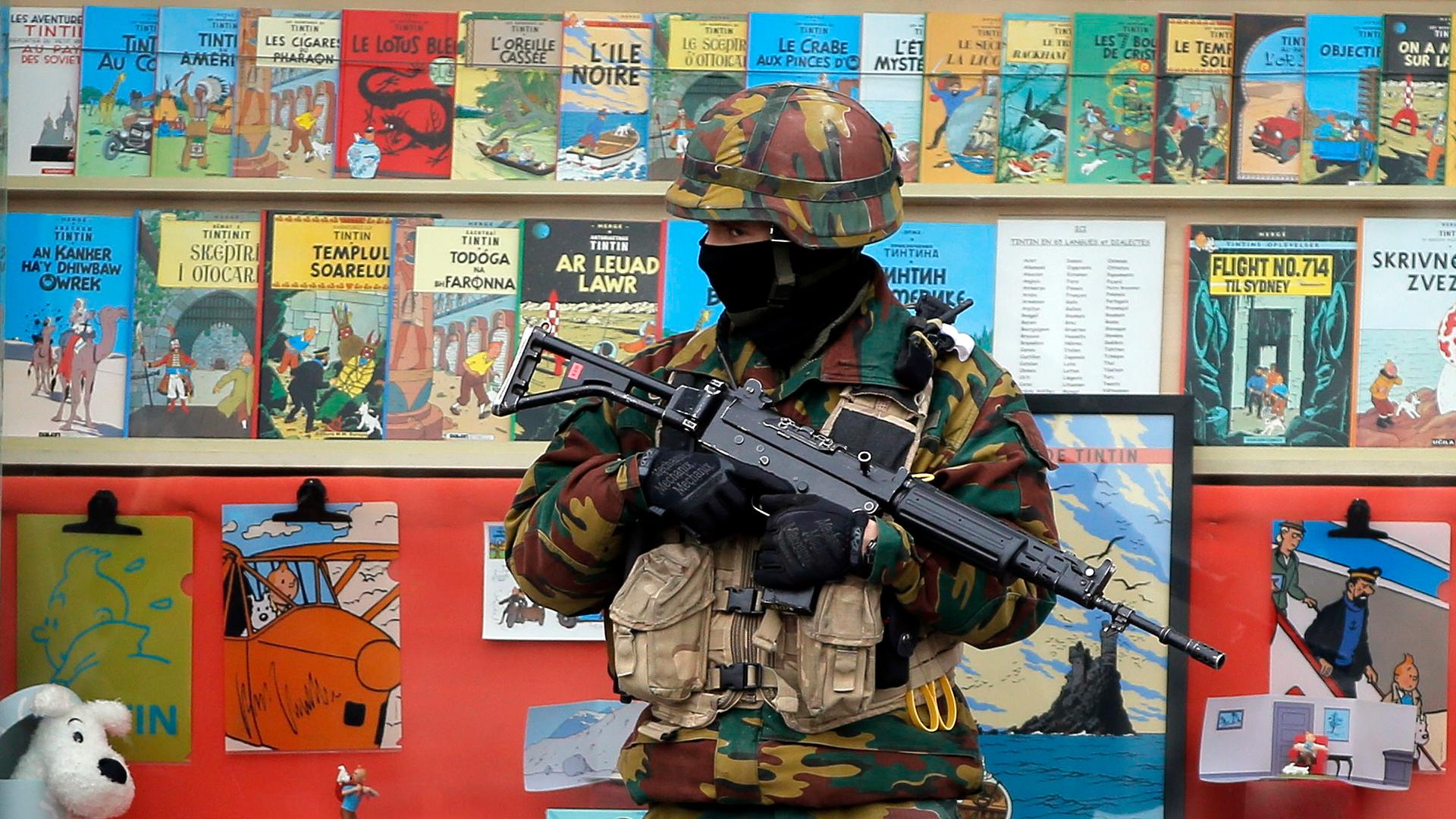 A Belgian soldier stands guard in front of a book store in central Brussels
