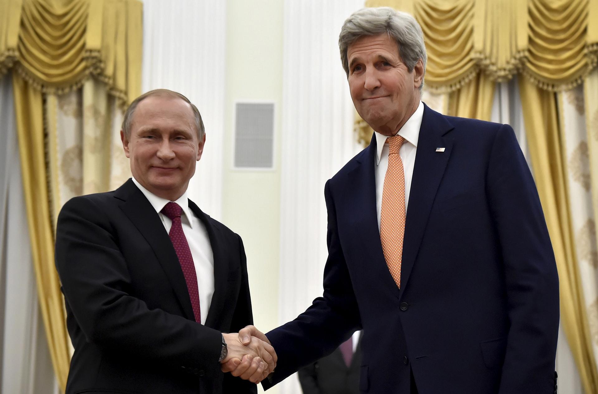 Russian President Vladimir Putin shakes hands with U.S. Secretary of State John Kerry at the Kremlin in Moscow, Russia.
