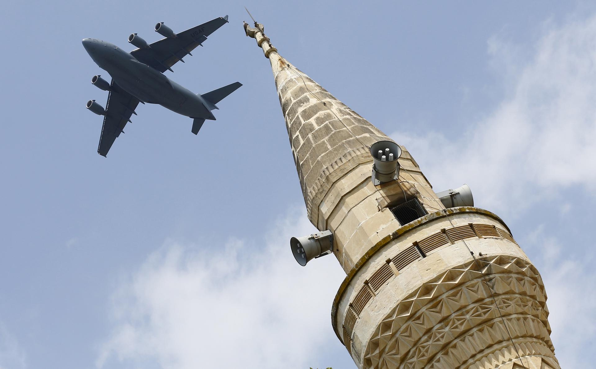 A US Air Force transport aircraft flies over a minaret after taking off from Incirlik air base in Adana, Turkey, in August 2015. After the attempted coup, operations at the air base were halted.