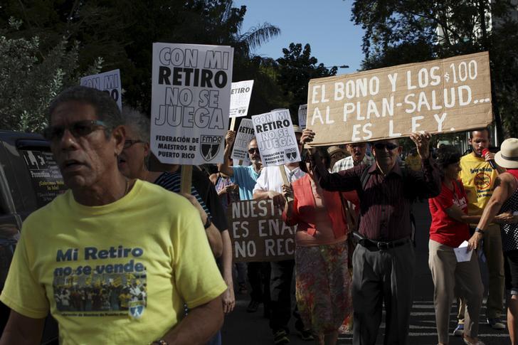 Retired teachers from Puerto Rico's Teachers Federation protest against the underfunding of their pension system in San Juan, March 18, 2016. The sign reads "Don't play with my retirement."
